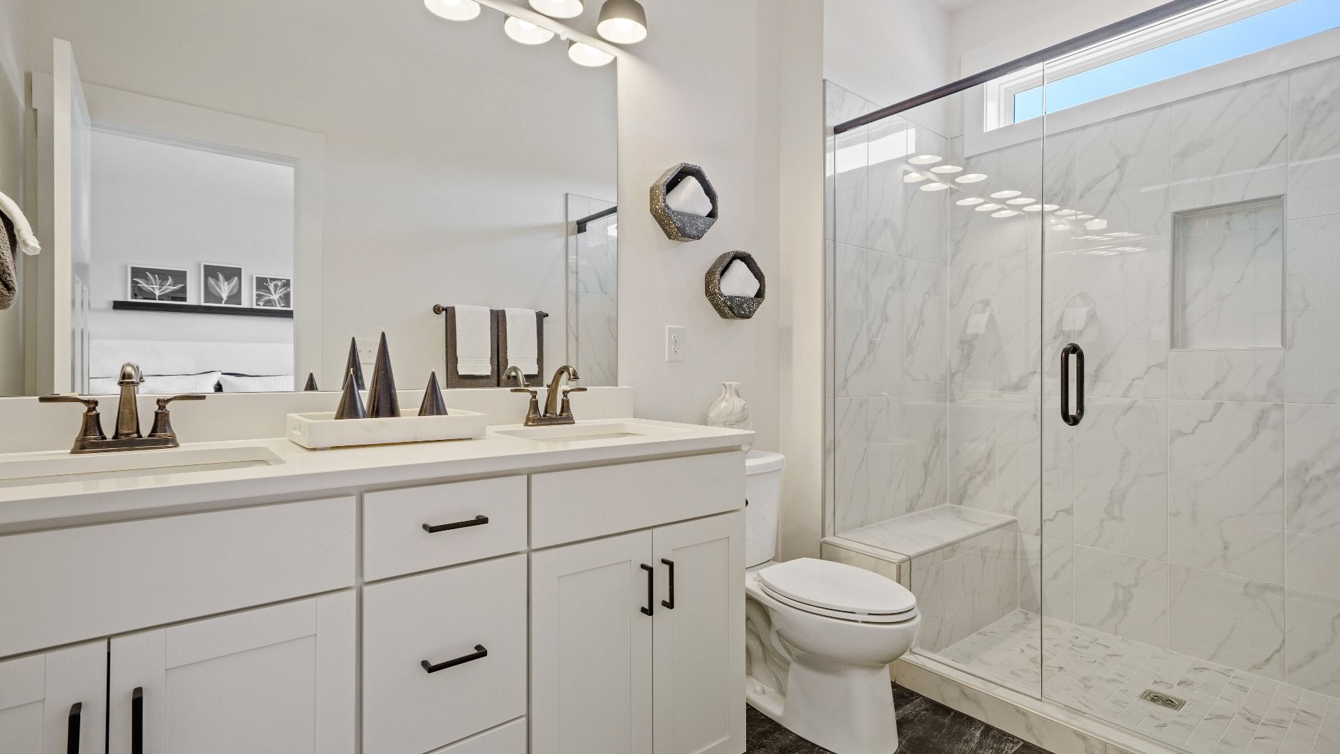 Spacious and modern primary bathroom with walk-in shower and first-class double vanity setup at Montgomery Chase