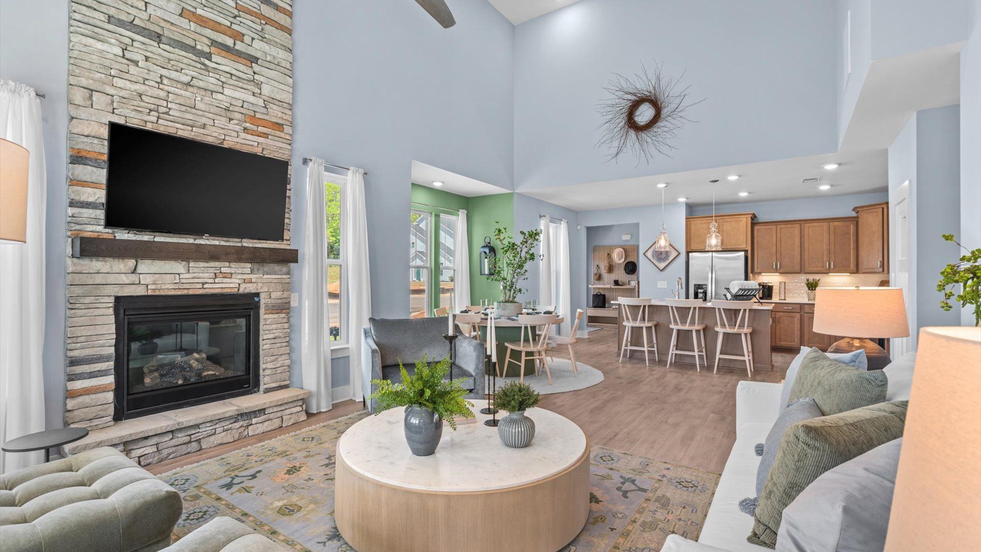 Memorable moments begin in this elegant, open family room with hardwood flooring and refined finishes in Greenville, SC