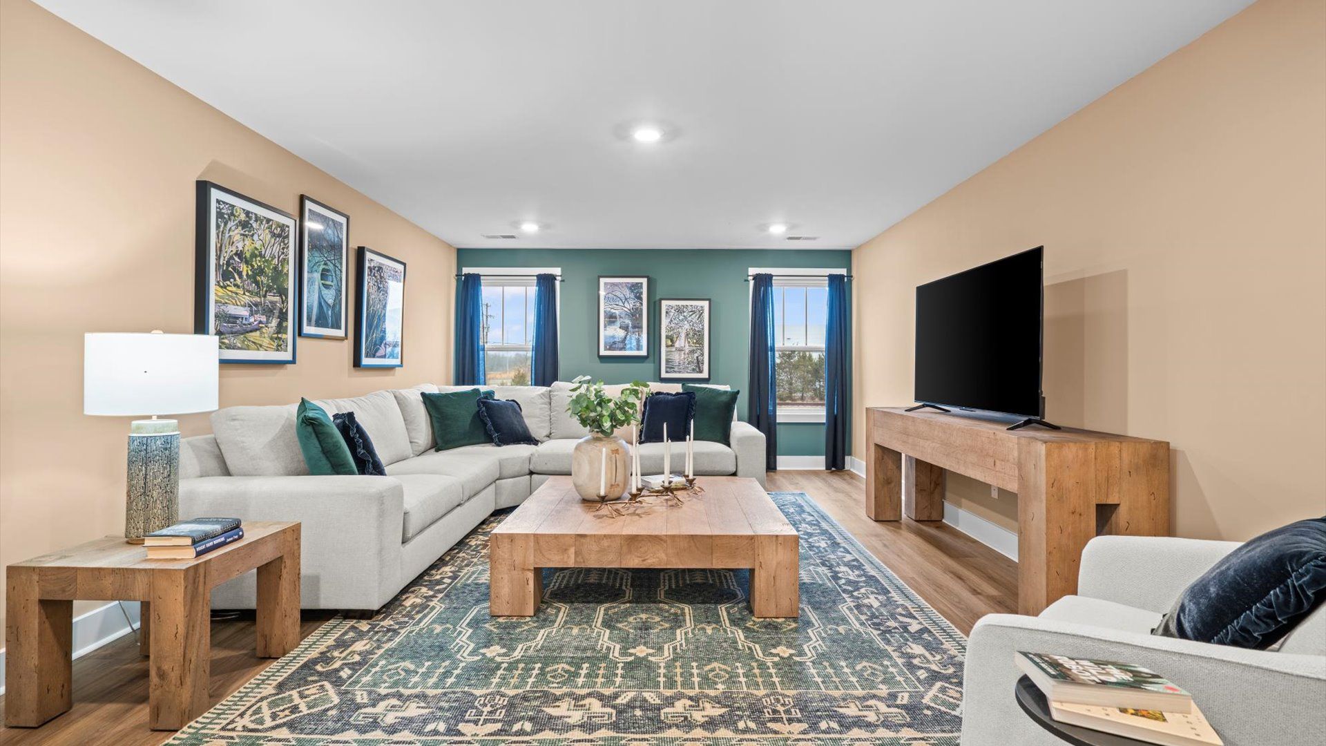 Functional loft with tasteful hardwood floors and exceptional natural light in a modern home at Robert's Farm