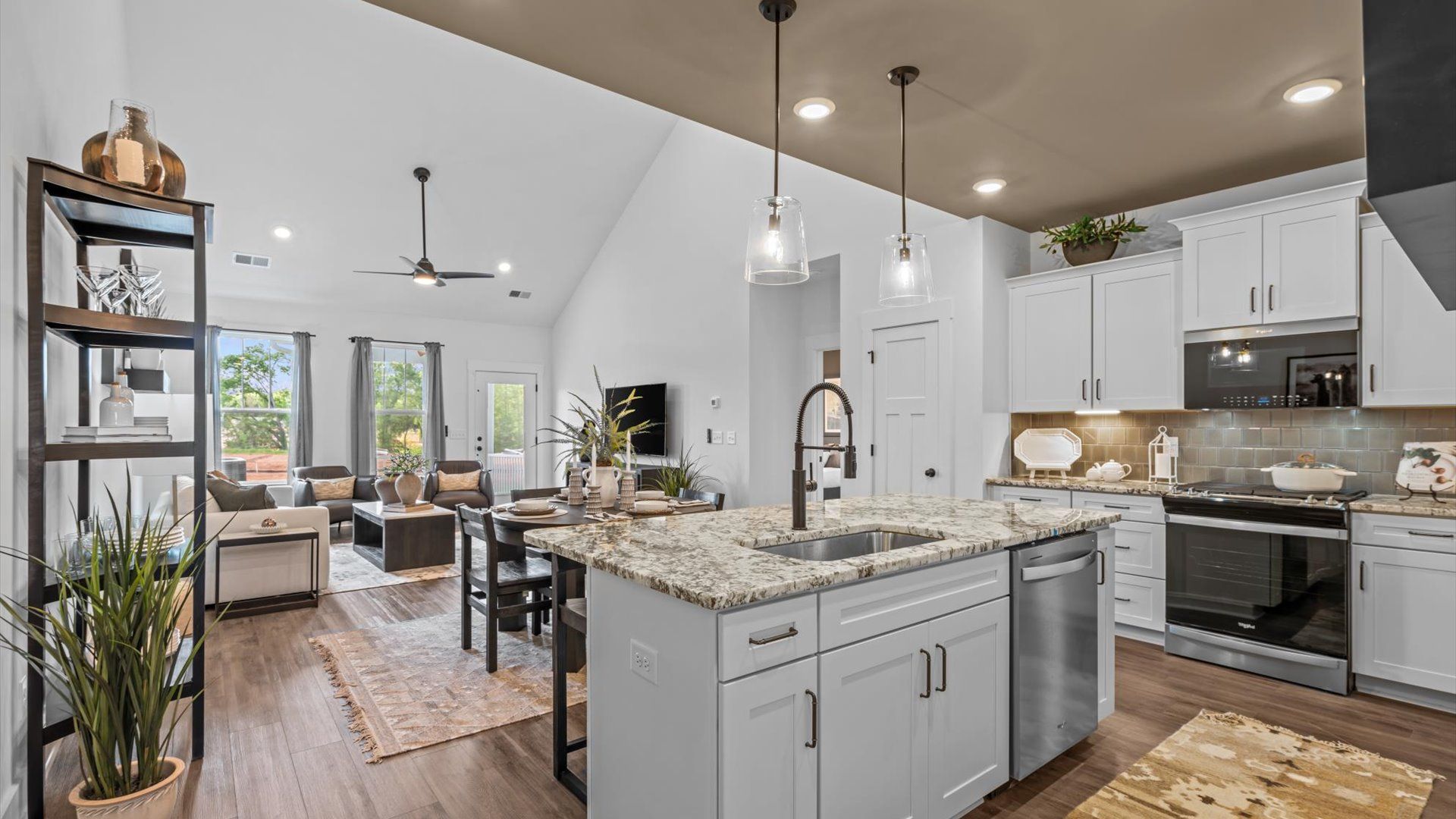 Exceptional kitchen featuring a spacious island, eye-catching pendant lights, and modern finishes by DRB Homes