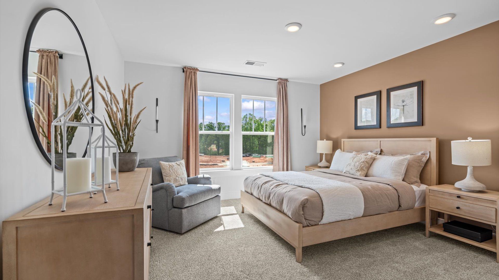 Inviting bedroom with tasteful finishes and large windows that create a fresh, open ambiance at the Robert's Farm community
