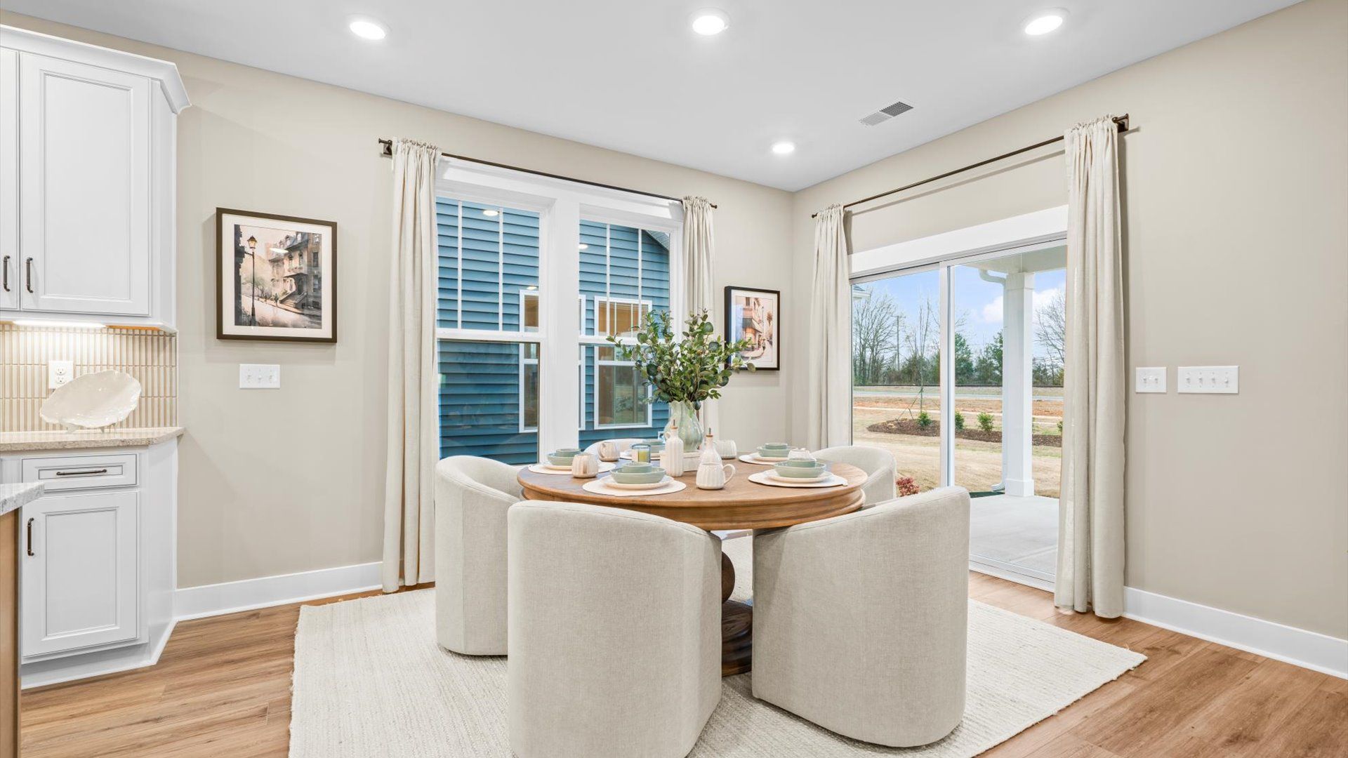 Tasteful dining area with current design in this vibrant two-story home at the new Robert's Farm community