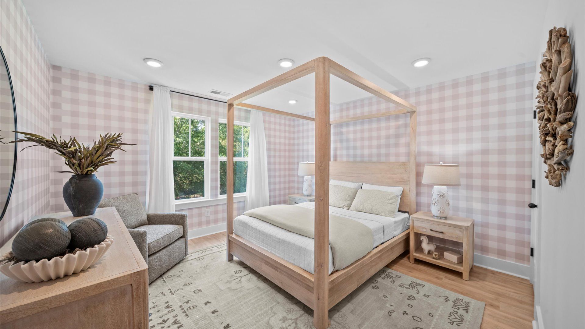 Elegant bedroom featuring hardwood floors and oversized windows that create a bright, welcoming space at Robert's Farm