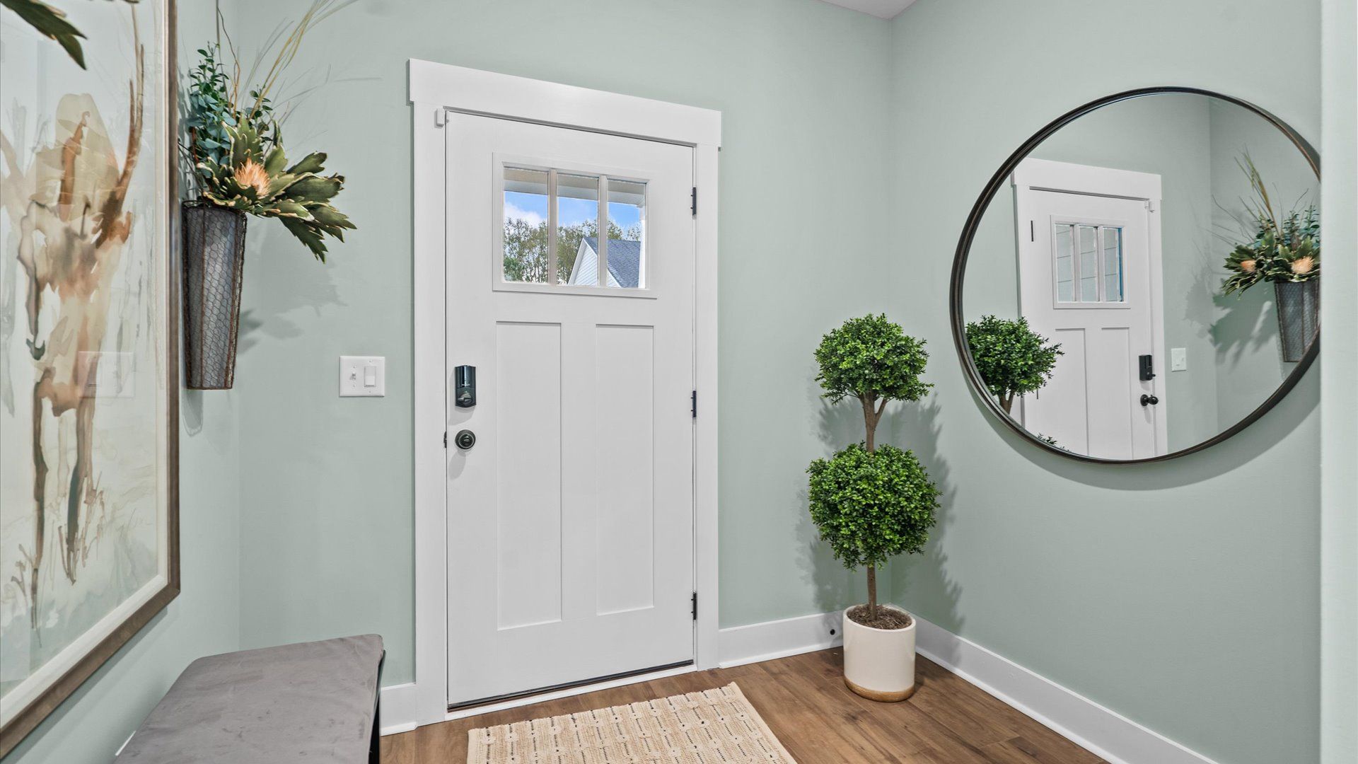 Accomplished hardwood flooring foyer sets the tone for tasteful design throughout the home in Simpsonville, SC