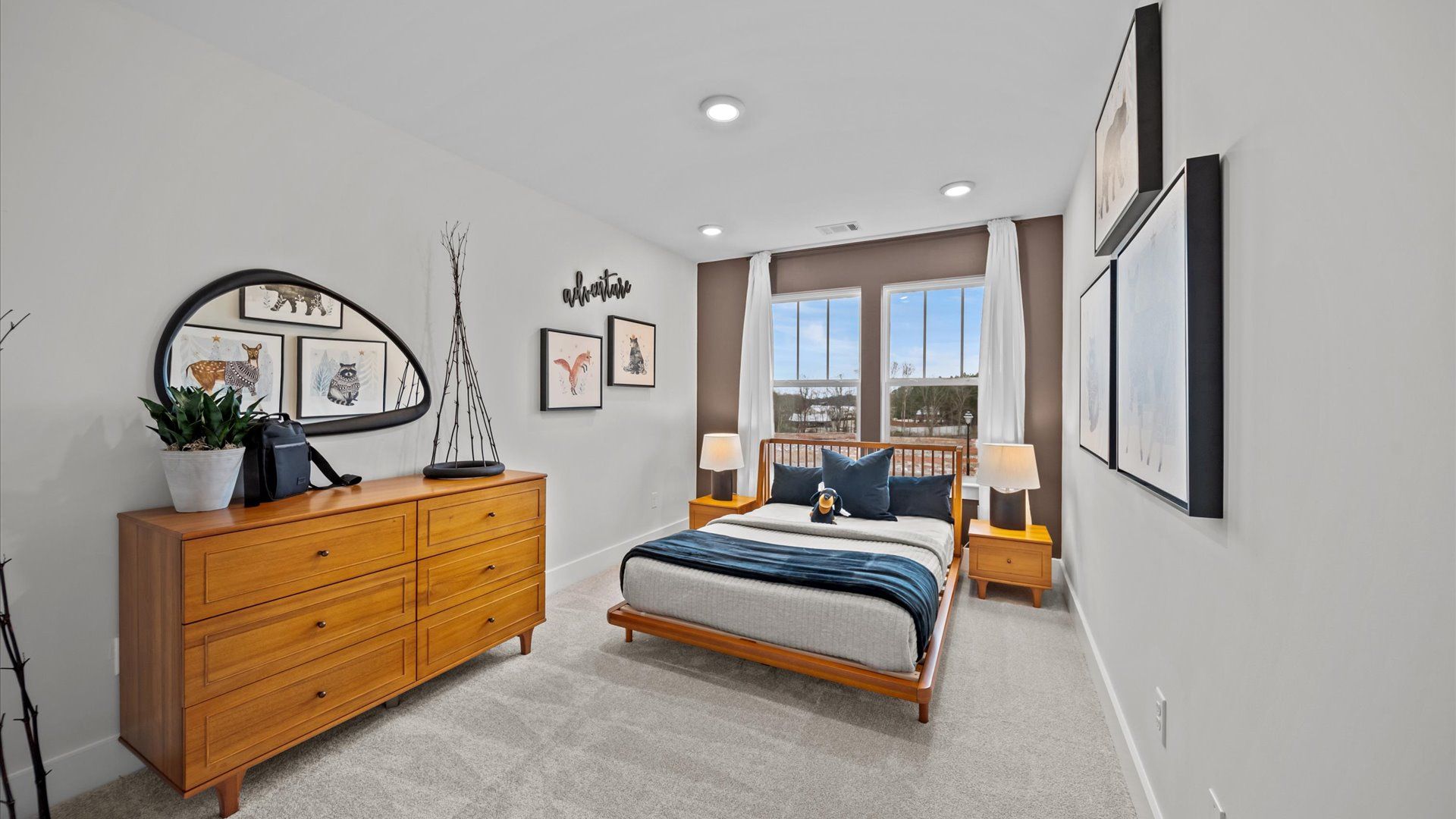 Highly functional bedroom with large windows, carpeted flooring, and tasteful finishes throughout