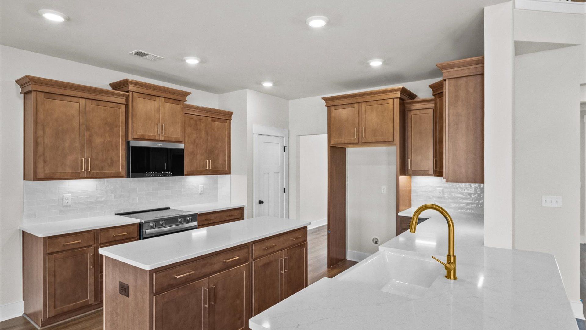 Bright and airy culinary space with generous prep areas and contemporary lighting at Kayfield at Midway