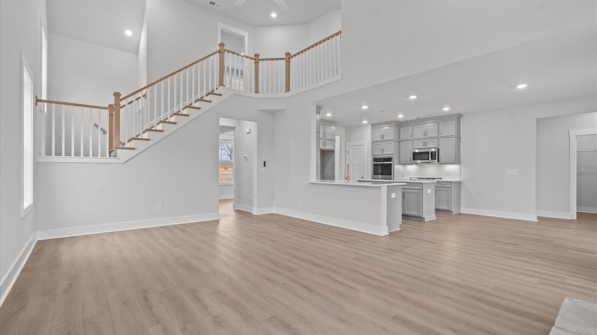Highly skilled craftsmanship and modern elegance meet in this family room with soaring ceilings in Anderson, SC