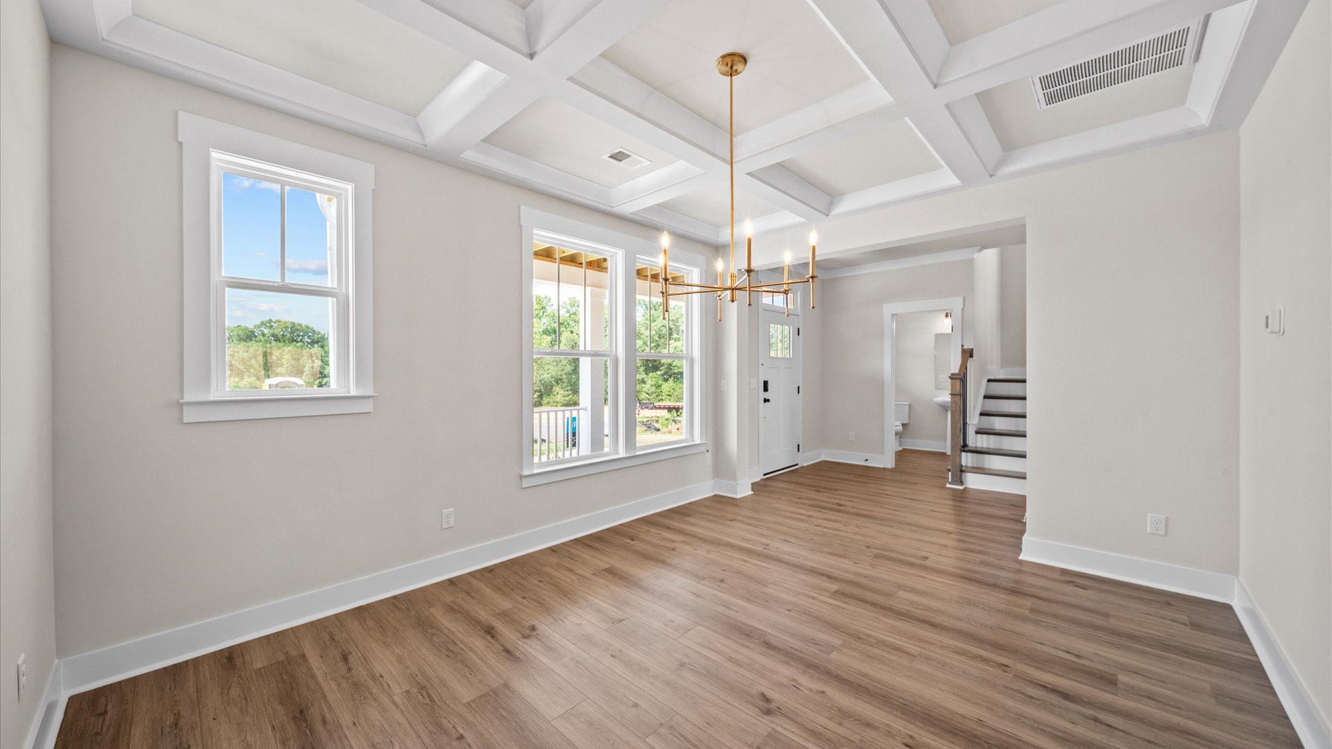 Coffered ceiling detail brings depth and sophistication to this top-notch formal dining room at the Wells Crossing community