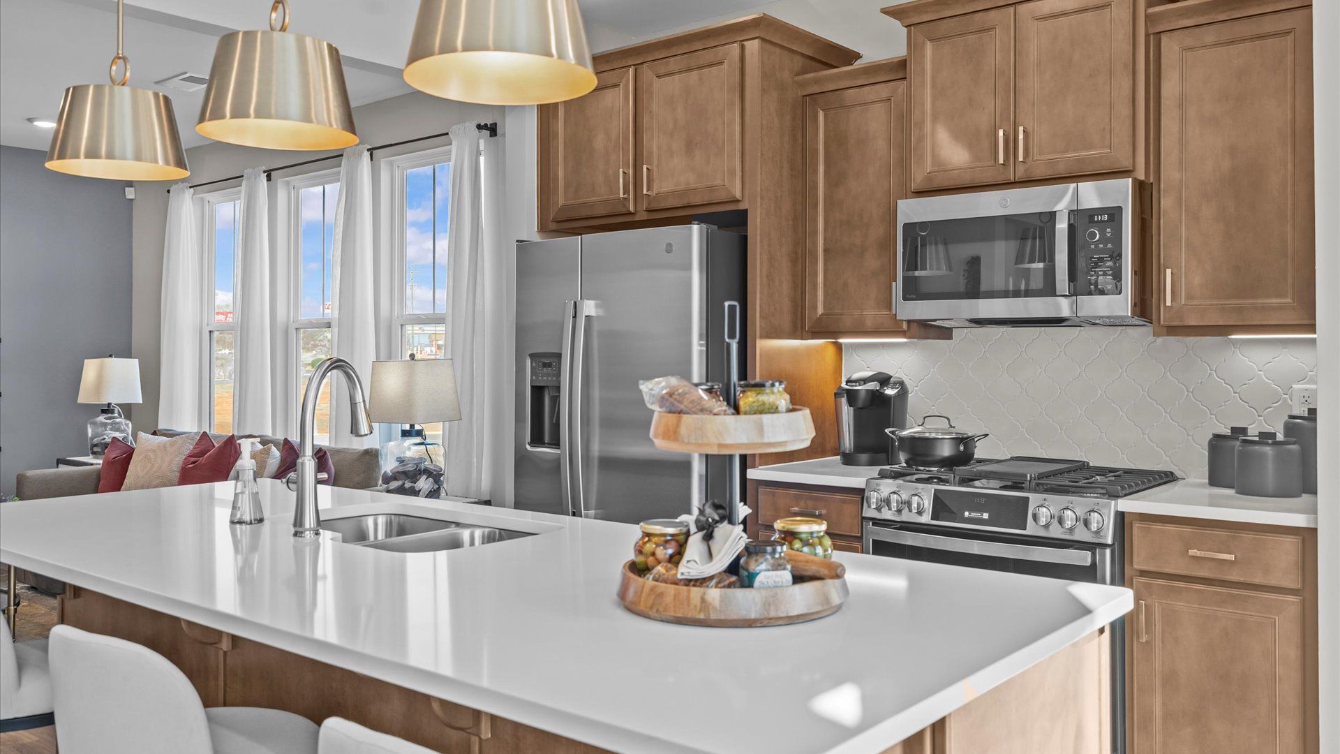 Modern farmhouse kitchen with wooden cabinetry in two story townhome at Saluda Crossing by DRB Homes in Piedmont, SC