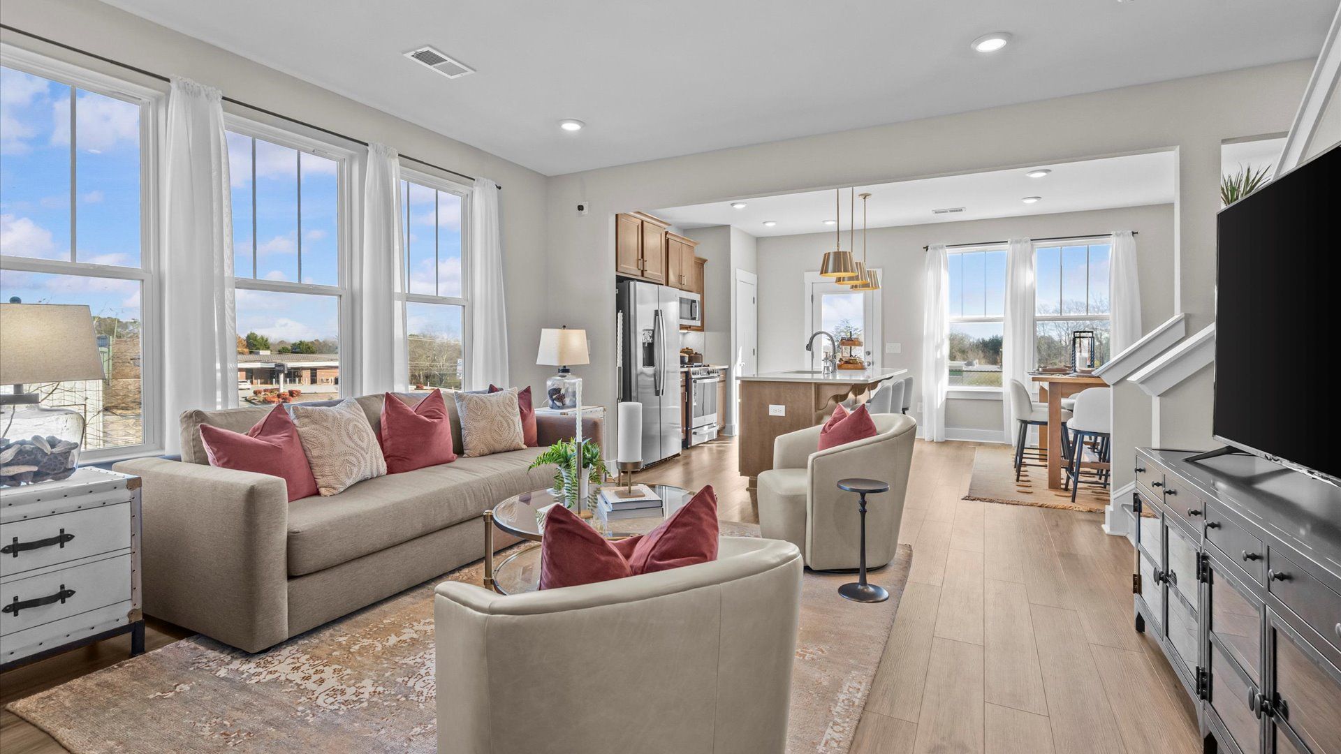 Hardwood flooring family room with elevated ceilings in two story townhome at Saluda Crossing by DRB Homes in Piedmont, SC