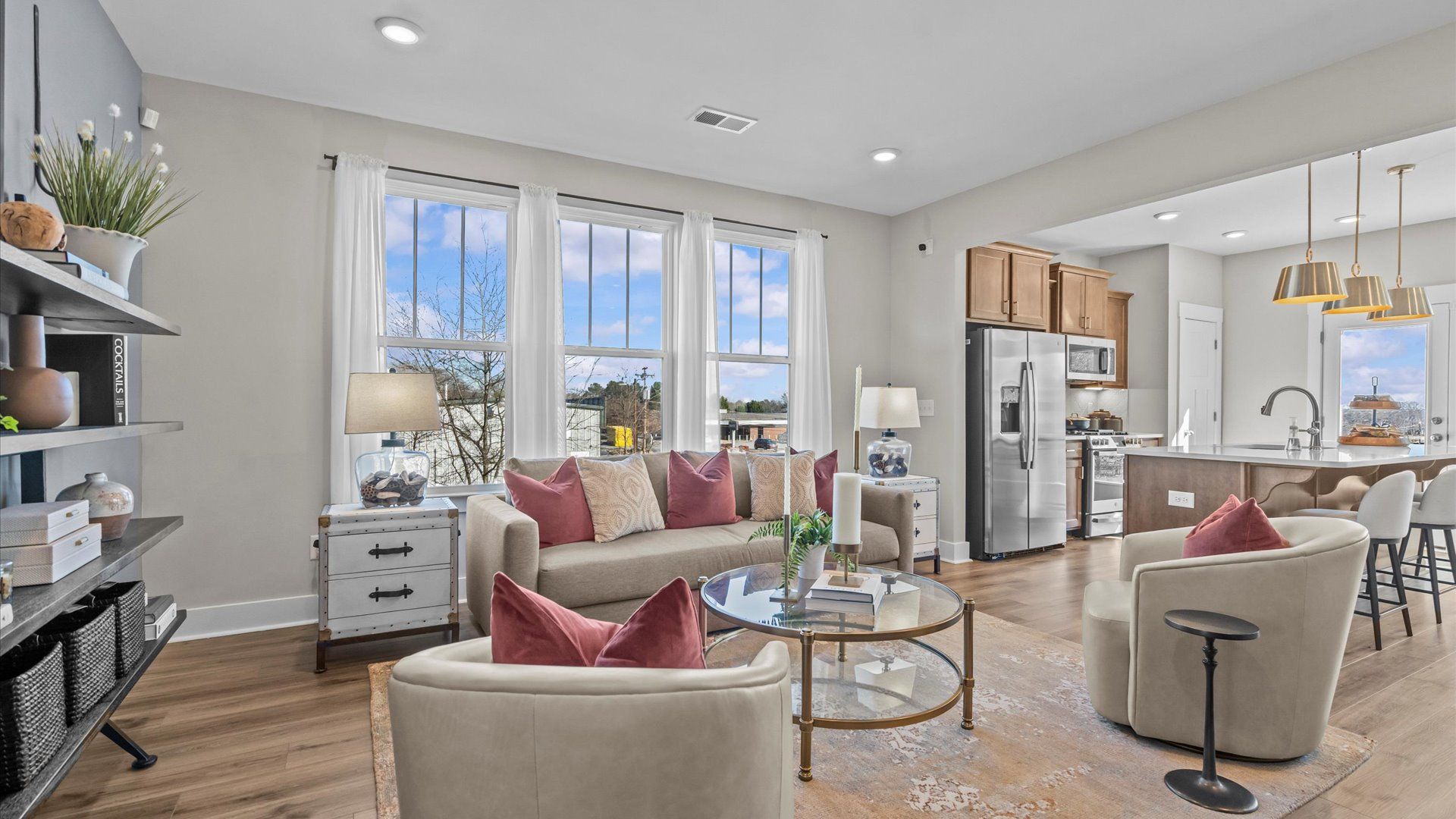 Cozy family room with ceiling fan and large windows in two story townhome at Saluda Crossing by DRB Homes in Piedmont, SC
