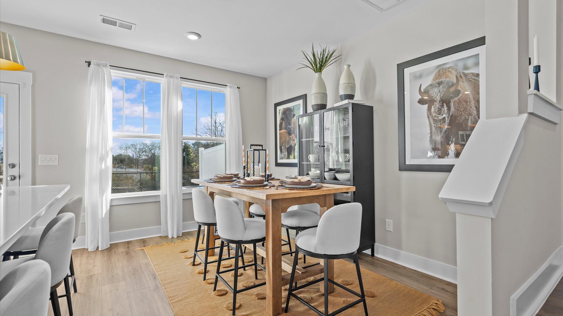 Modern farmhouse breakfast area with large windows in two story townhome at Saluda Crossing by DRB Homes in Piedmont, SC