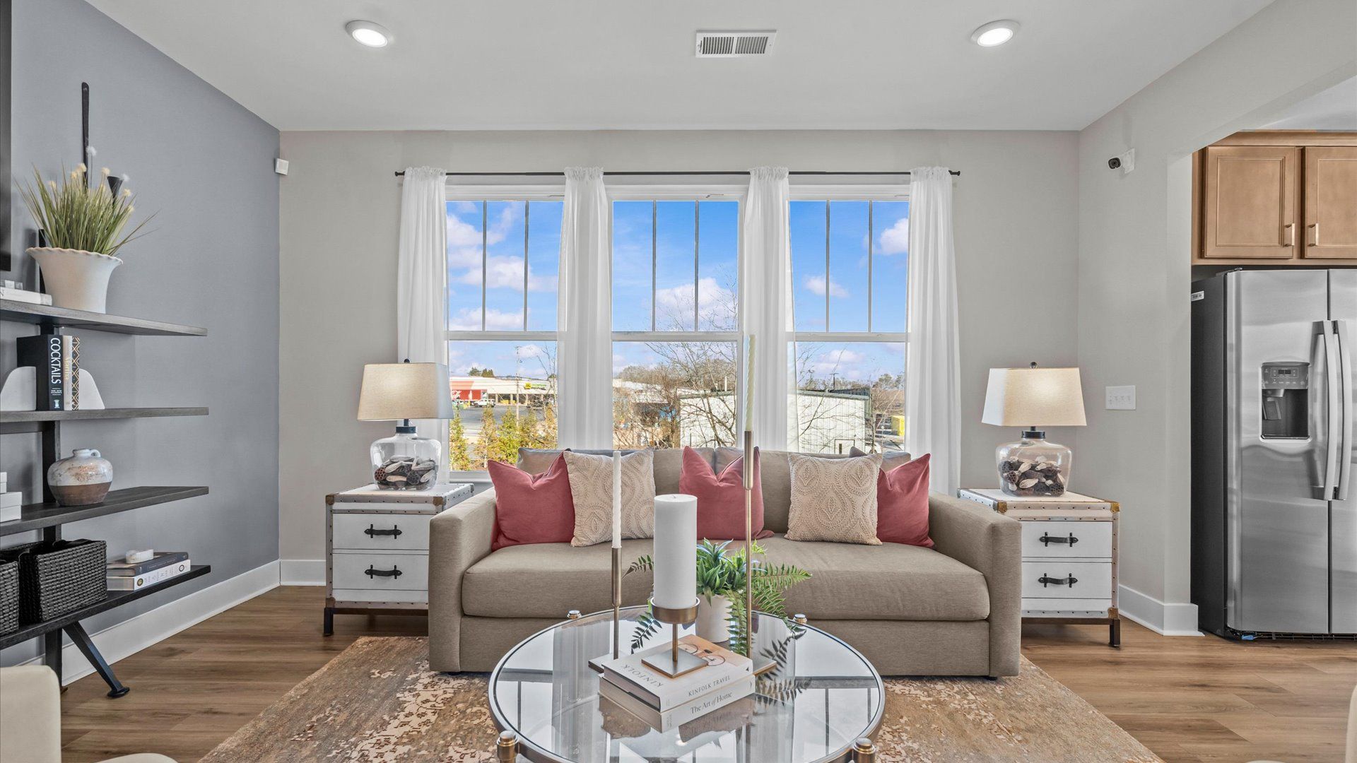 Spacious, cozy, modern family room with hardwood floors and large windows at Saluda Crossing by DRB Homes in Piedmont, SC