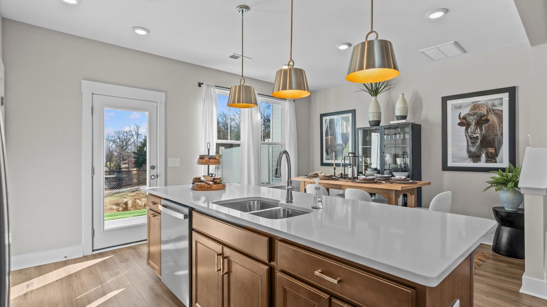 Wooden cabinetry kitchen with white quartz countertops in two story townhome at Saluda Crossing by DRB Homes in Piedmont, SC