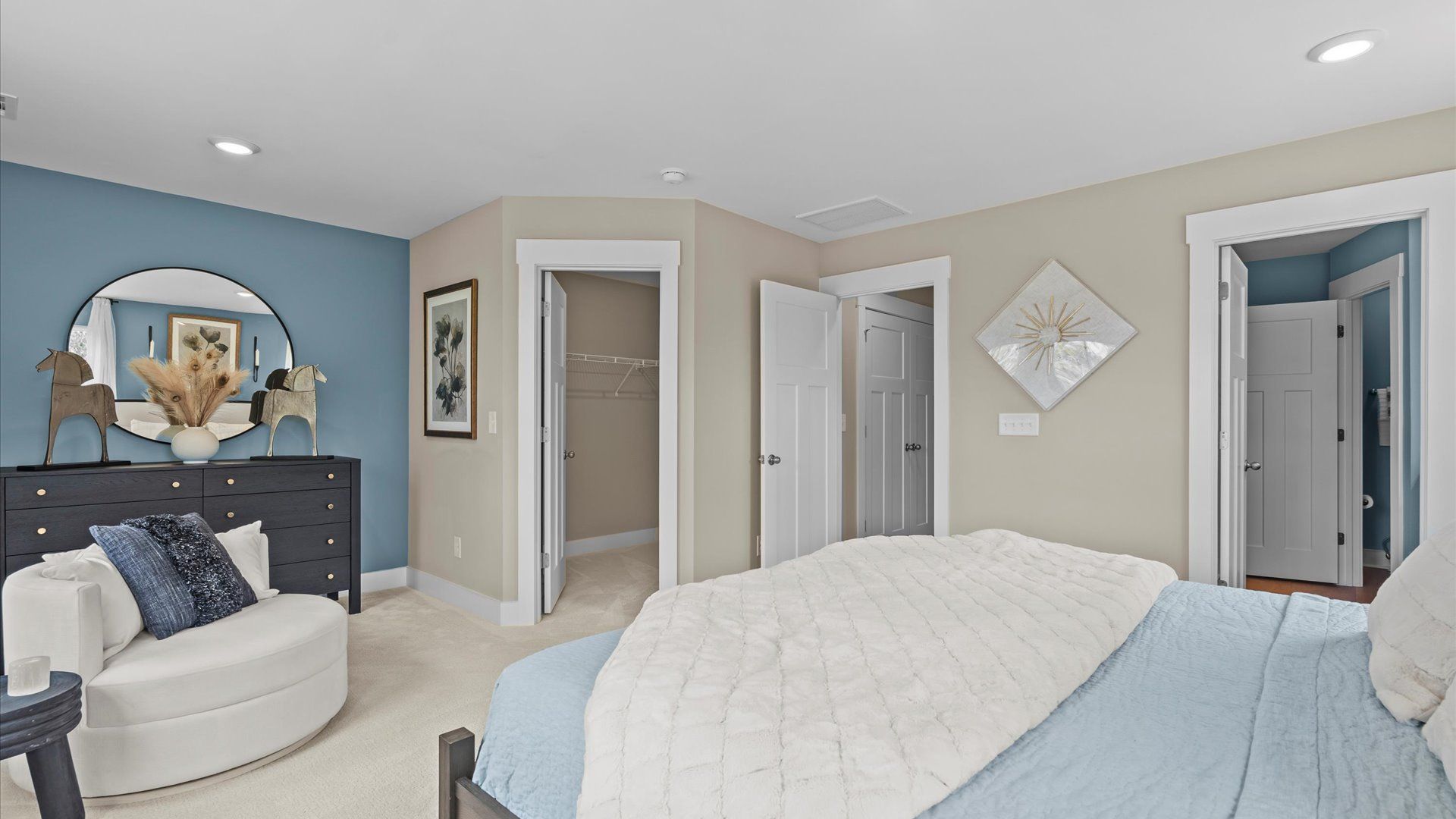 Plush carpeted primary suite with multiple large windows in two story townhome at Saluda Crossing by DRB Homes