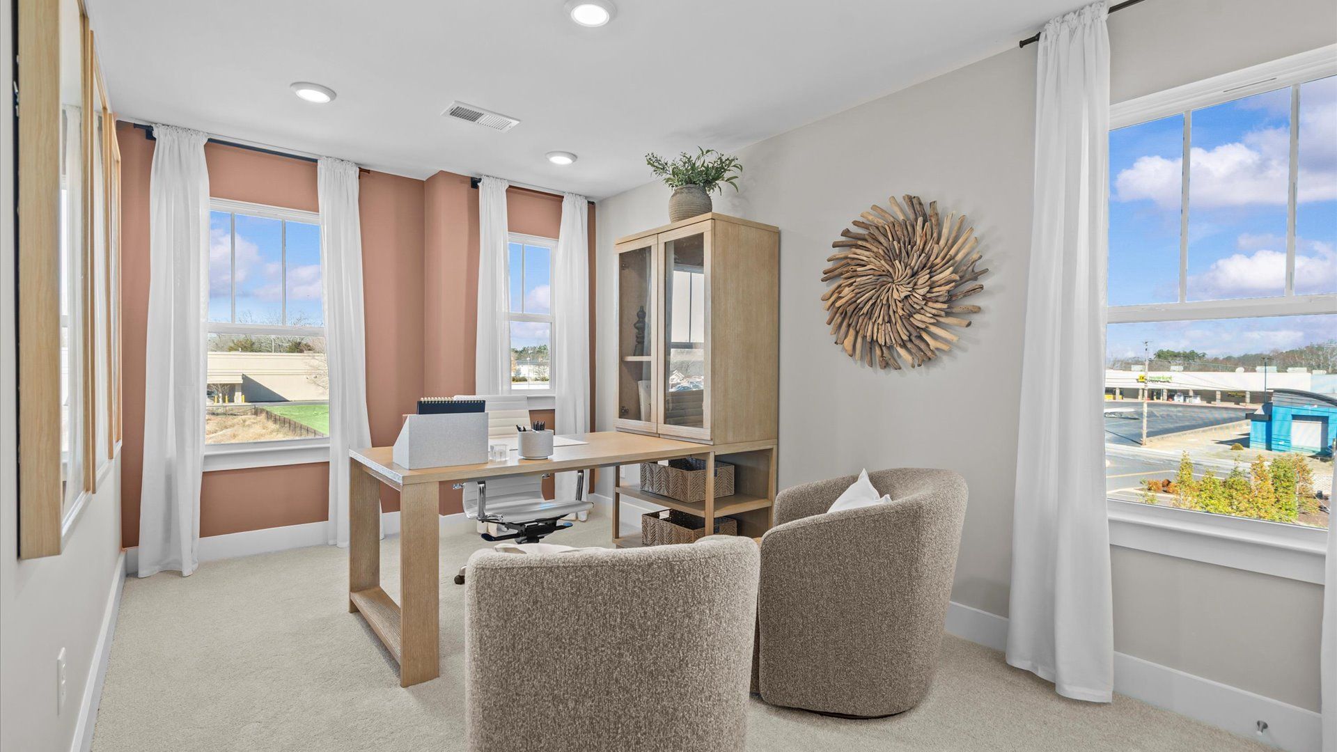 Study with plush carpet and large windows in two story townhome at Saluda Crossing by DRB Homes in Piedmont, SC