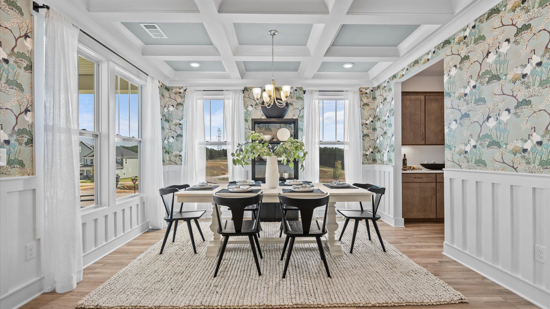 Eye-catching coffered ceiling adds charm to the formal dining space in this superior DRB Homes design