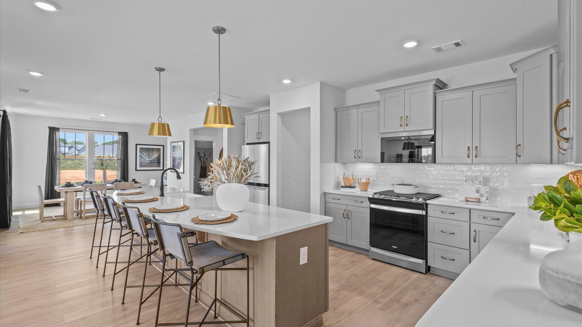 Highly skilled craftsmanship shines in this modern kitchen with pendant lighting and a central island focal point