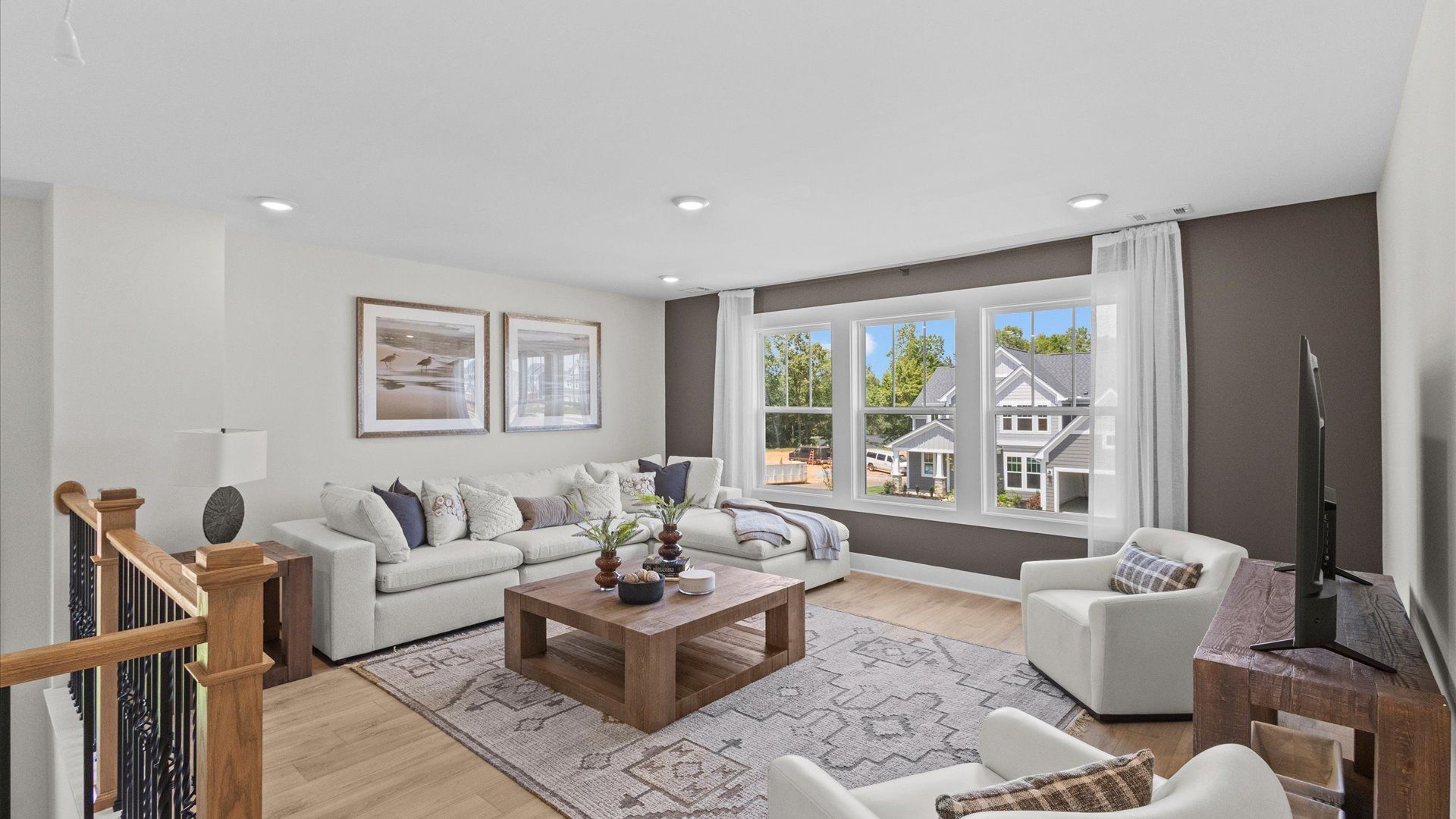 Hardwood flooring enhances the versatility of this elegant upper-level loft space at the new Easler Farm community
