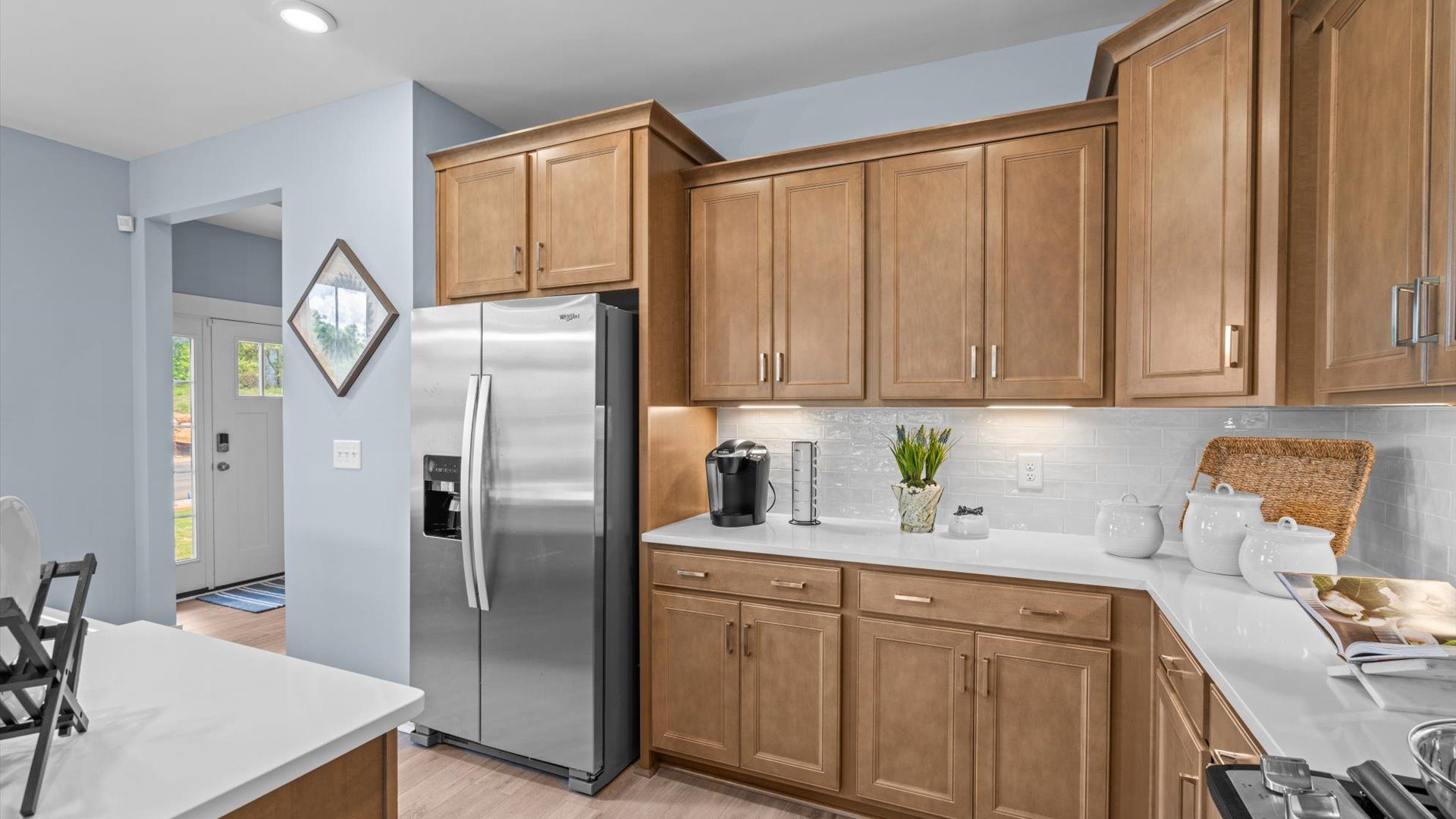 Bright and airy culinary space with generous prep areas and contemporary lighting at the new Barton Hollow community