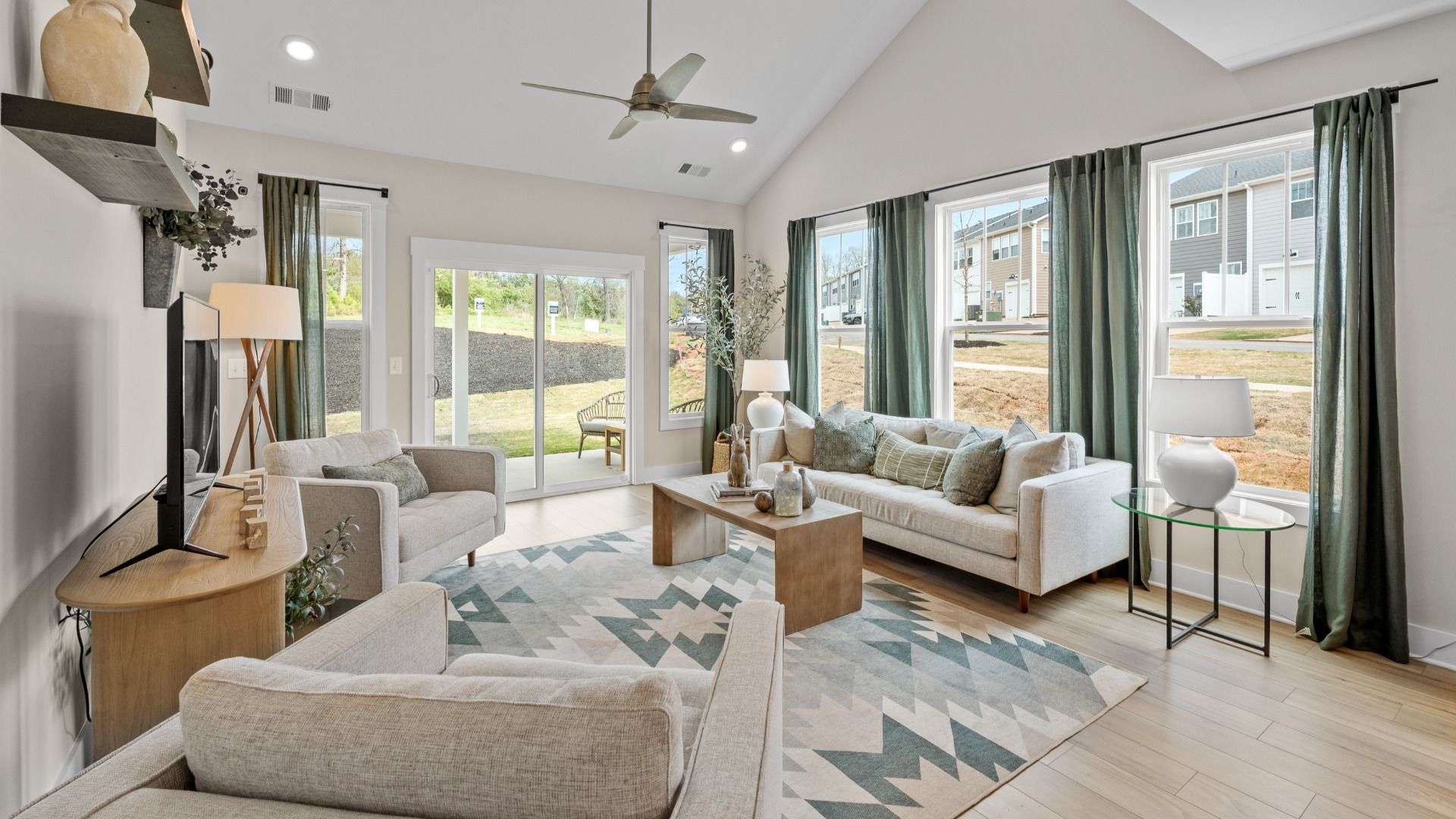 Spacious family room with rich hardwood flooring and elegant trim work in a reputable DRB Homes build
