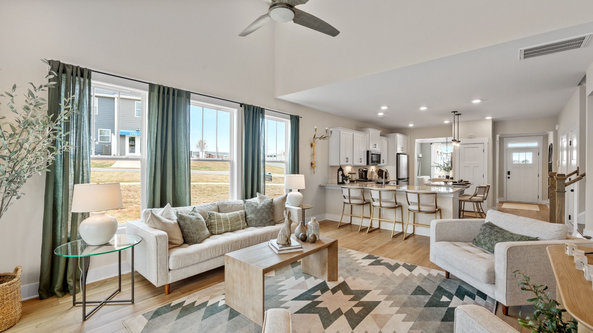First-class living space featuring expansive ceilings, elegant design, and open sightlines to the kitchen at Barton Hollow