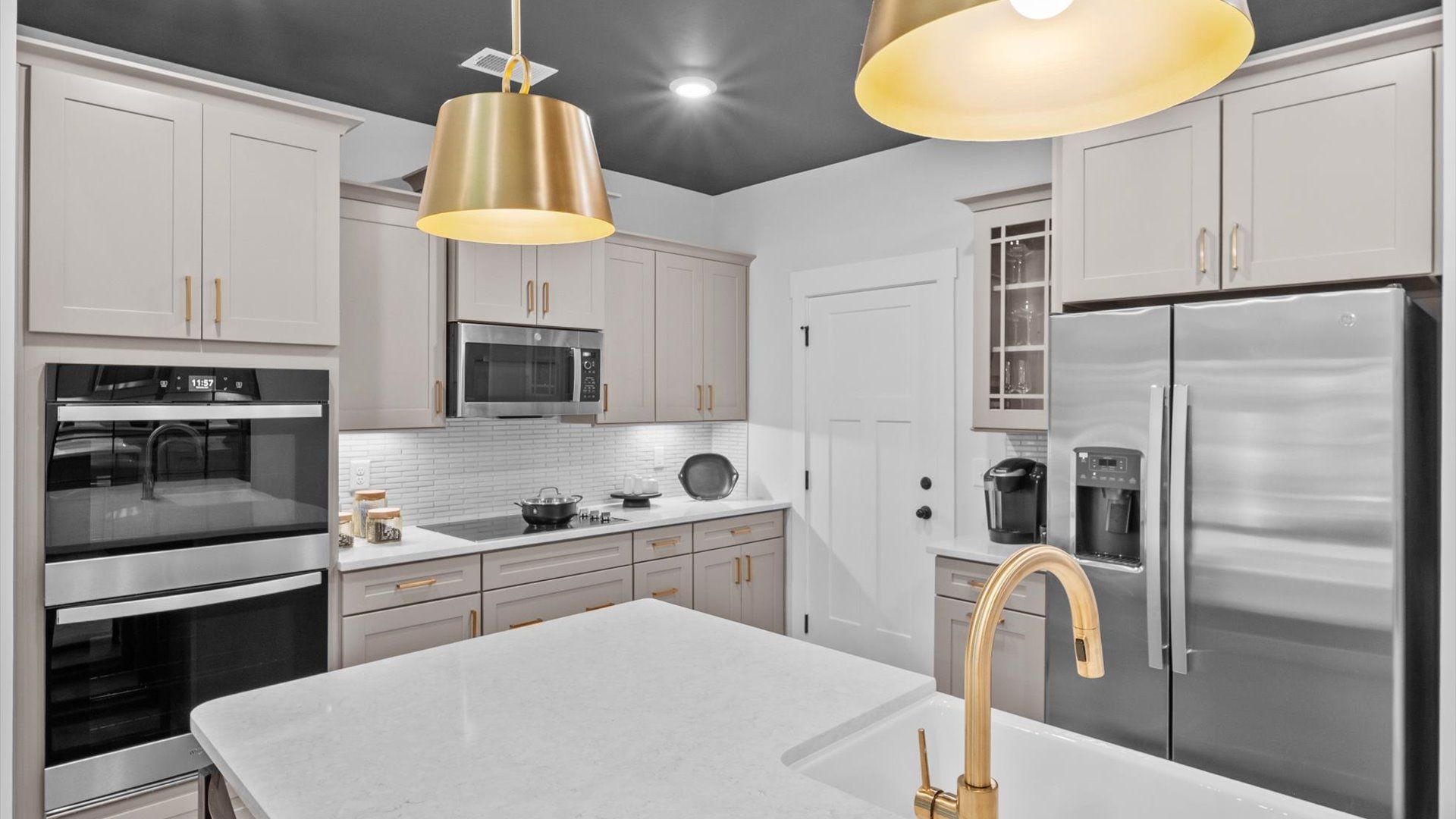 Exceptional kitchen featuring a spacious island, eye-catching pendant lights, and modern finishes at Barton Hollow