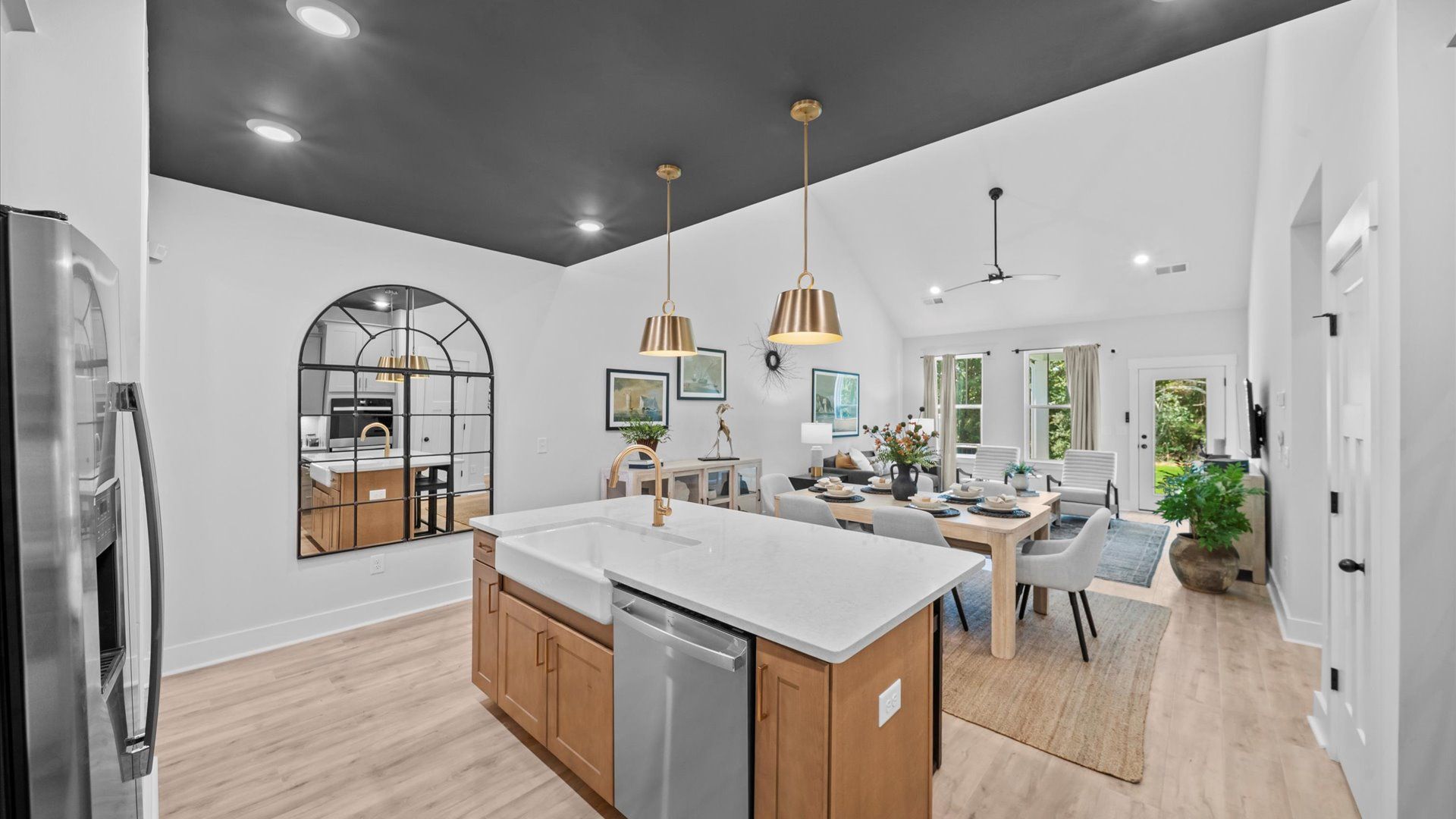 Highly skilled craftsmanship shines in this modern kitchen with pendant lighting and a central island focal point