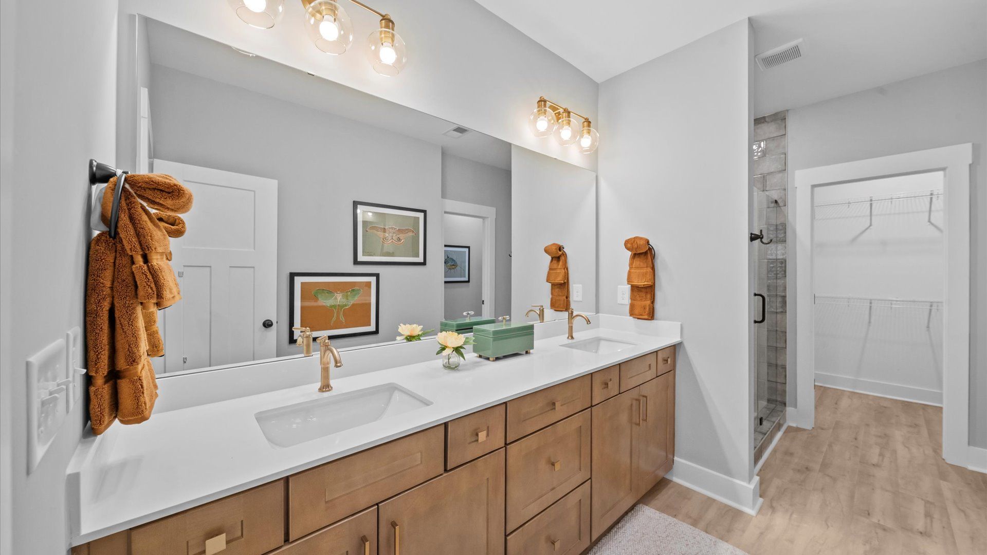 Spacious and modern primary bathroom with walk-in shower and first-class double vanity setup