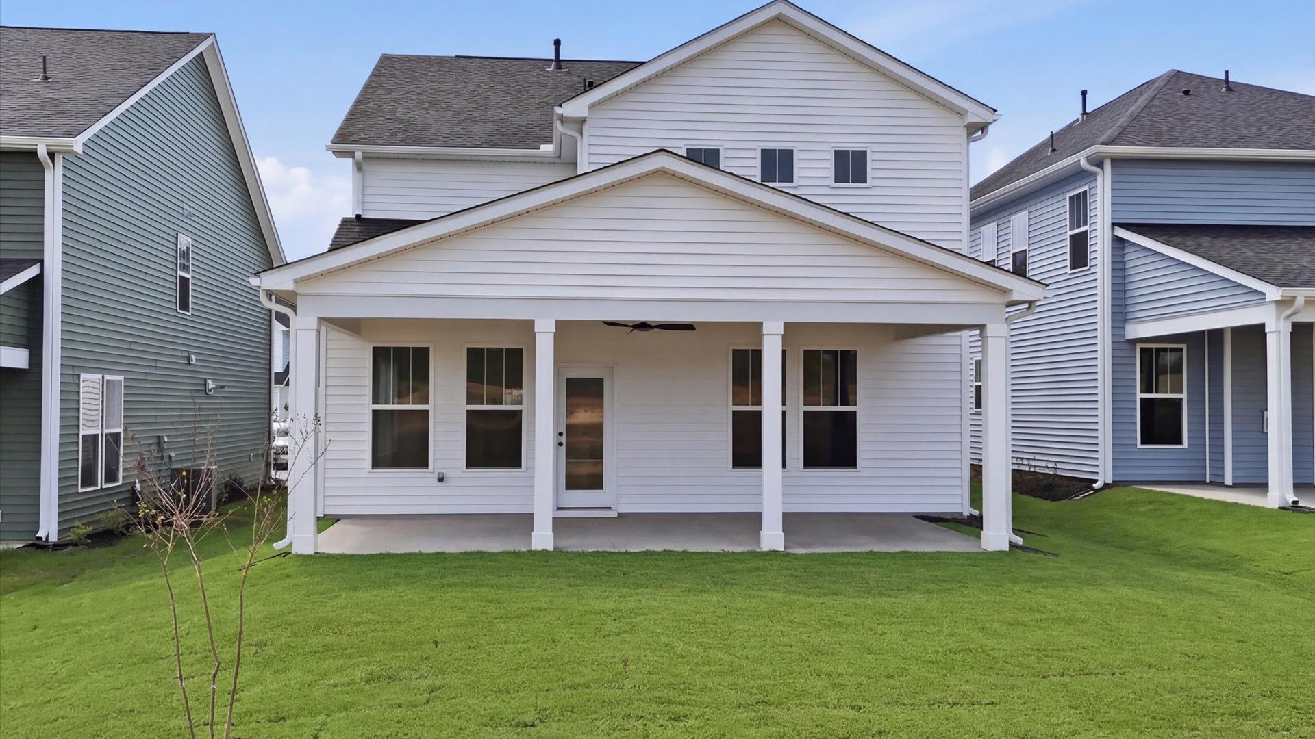 Refined rear exterior with a stylish covered porch for dining, relaxing, or entertaining at Harrier Point