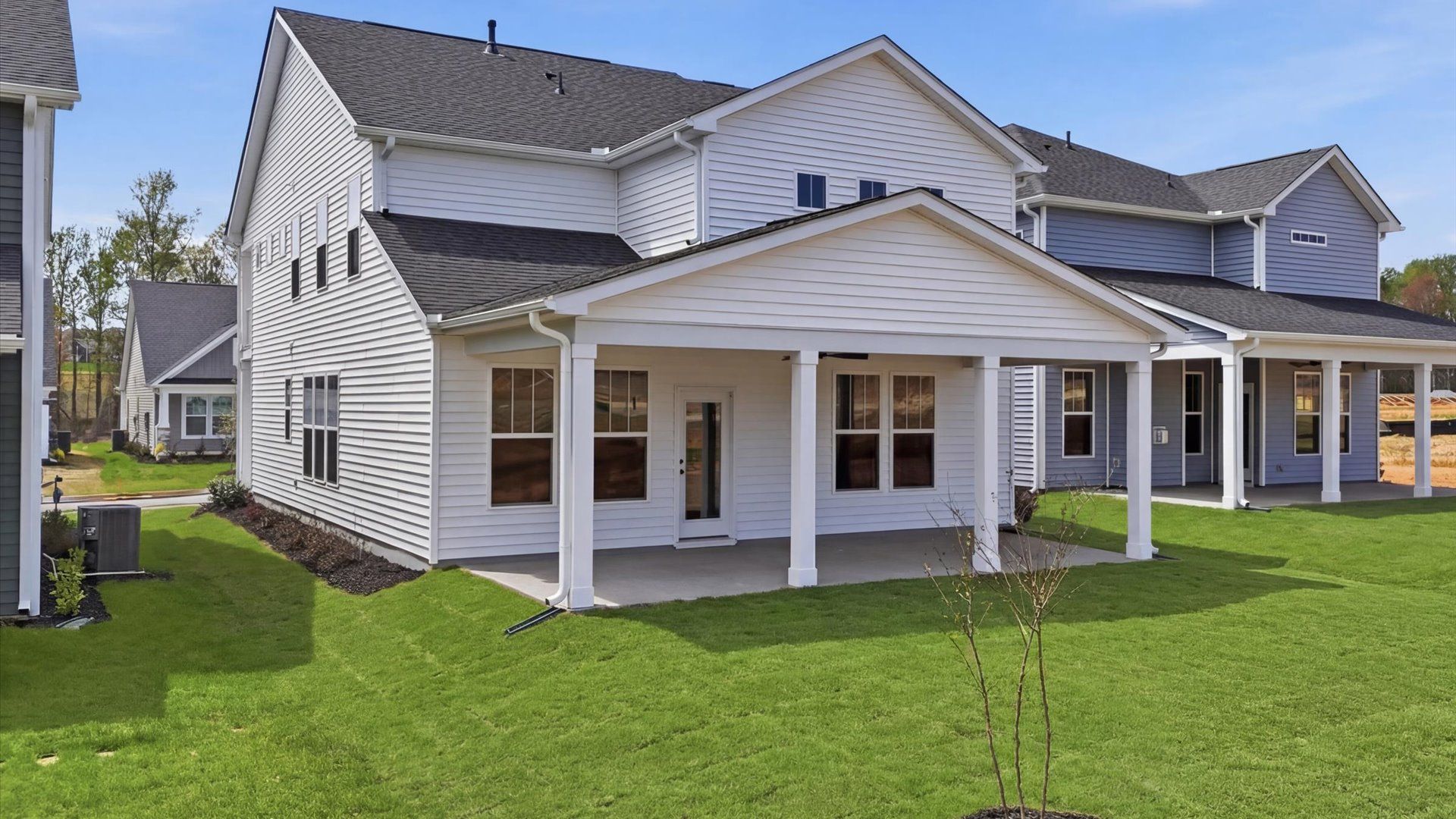 Elegant exterior with a rear covered porch—perfect for relaxing or entertaining outdoors at Harrier Point