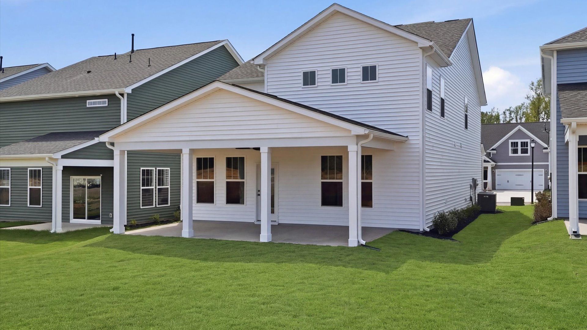 Highly functional rear covered porch adds memorable living space to this elegant home at Harrier Point