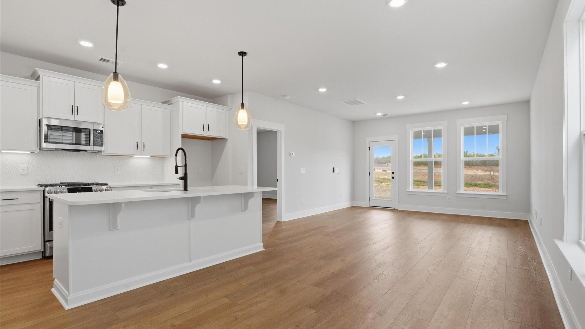 Tasteful kitchen with a streamlined island and modern finishes in a first-class DRB Homes design