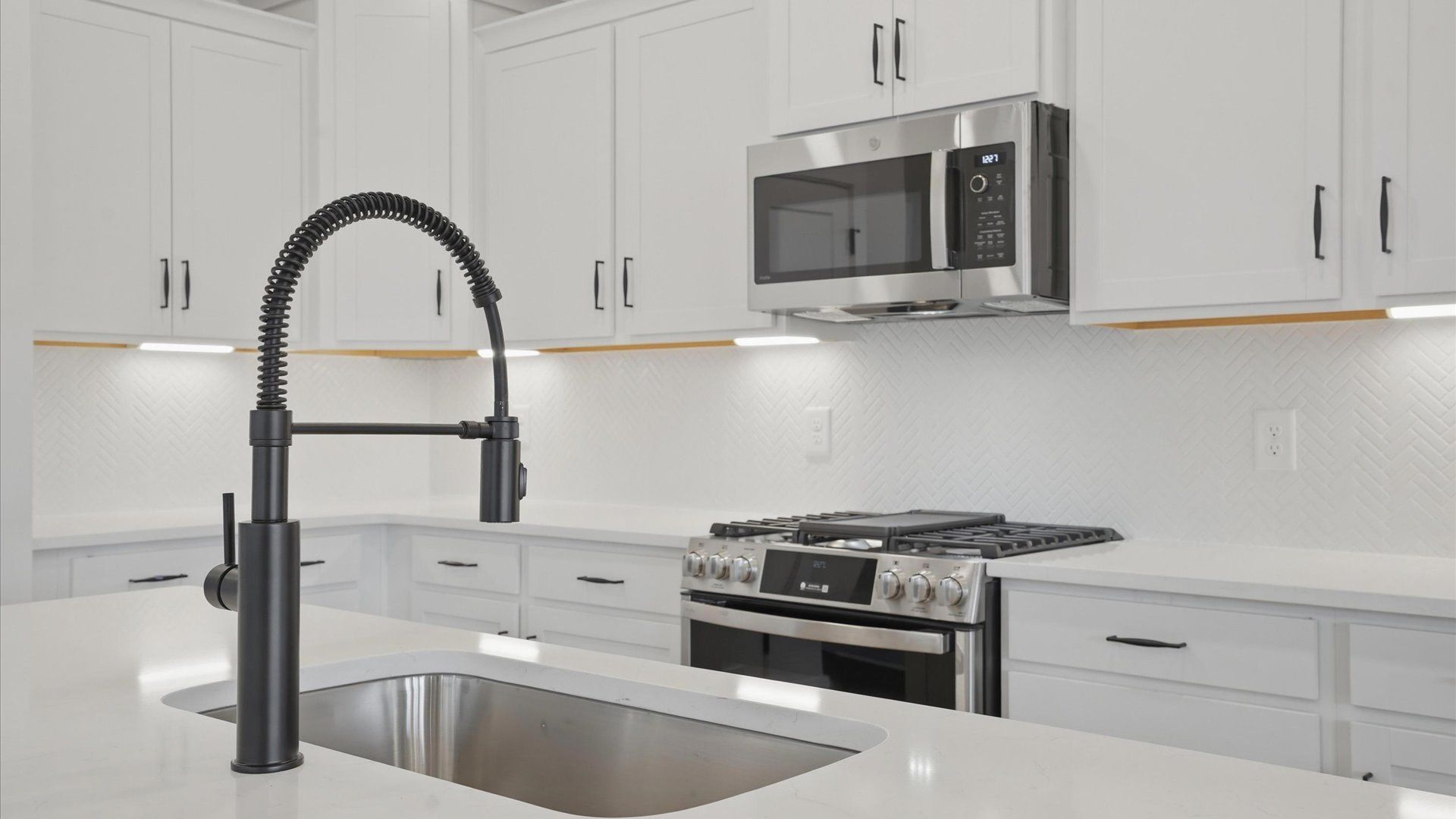 Memorable meals begin in this vibrant kitchen with quartz countertops and a thoughtfully designed island