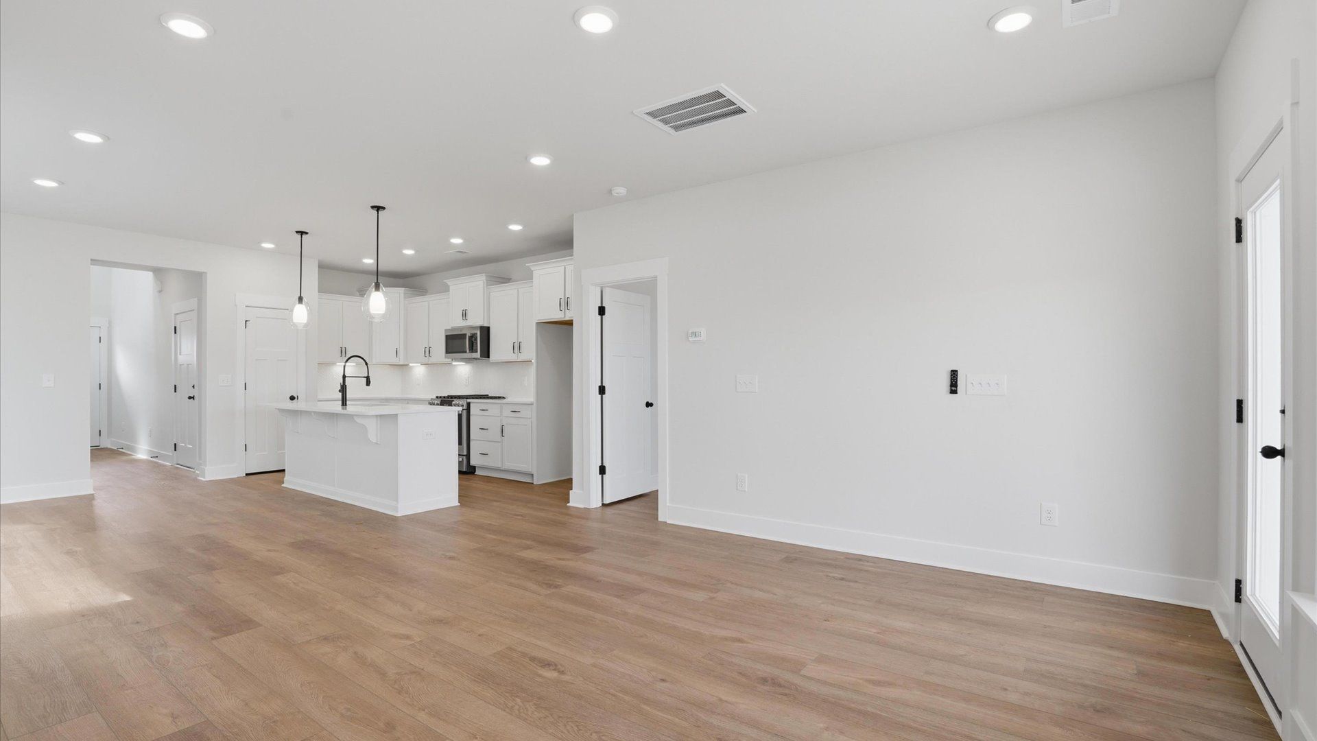 Exceptional family space with hardwood floors and seamless flow to dining and kitchen areas located at Harrier Point