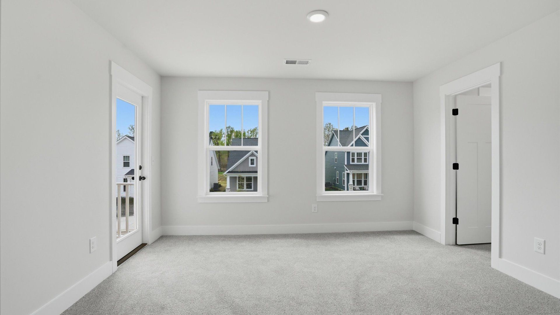 Memorable bedroom with plush carpet, a walk-in closet, and large windows for abundant natural light in Woodruff, SC