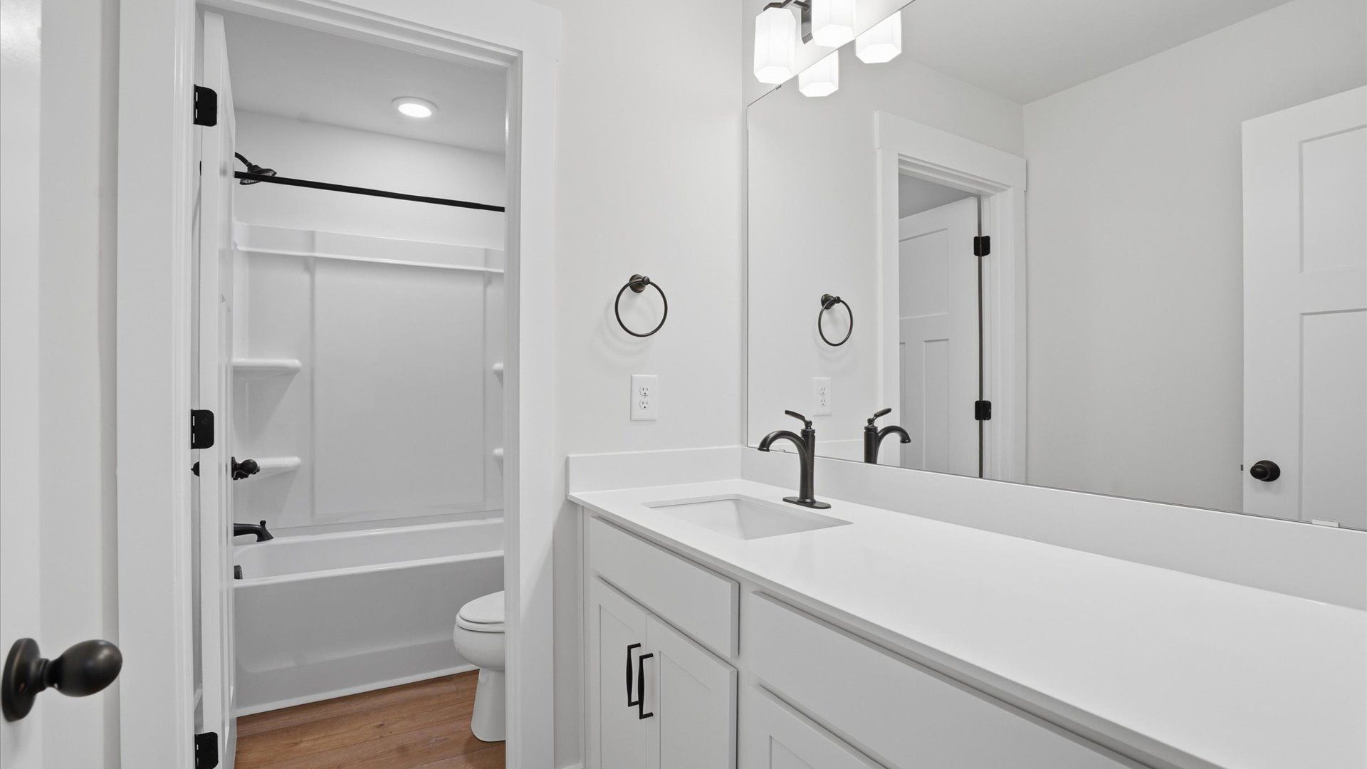 Highly skilled design seen in this polished and practical full bathroom at Harrier Point