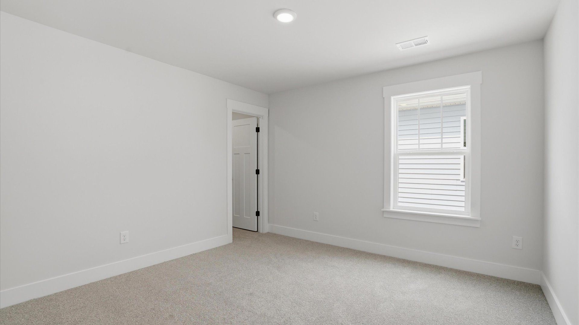 Notable secondary bedroom offering cozy carpeted flooring and a stylish walk-in closet located in Woodruff, SC