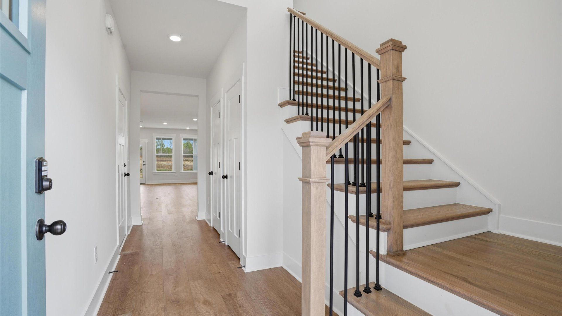 Accomplished hardwood flooring foyer sets the tone for tasteful design throughout the home at Harrier Point