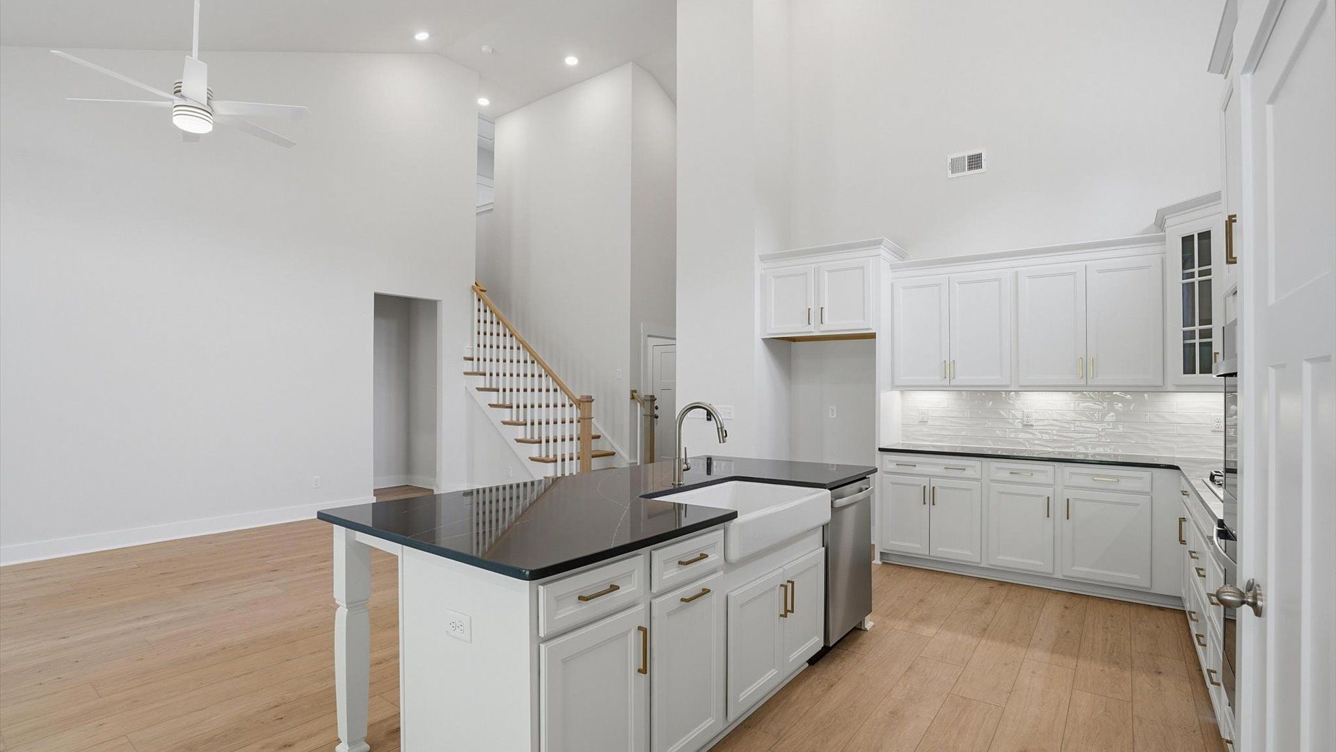 Exceptional kitchen featuring a spacious island, eye-catching features, and modern finishes at Pelham Crossing
