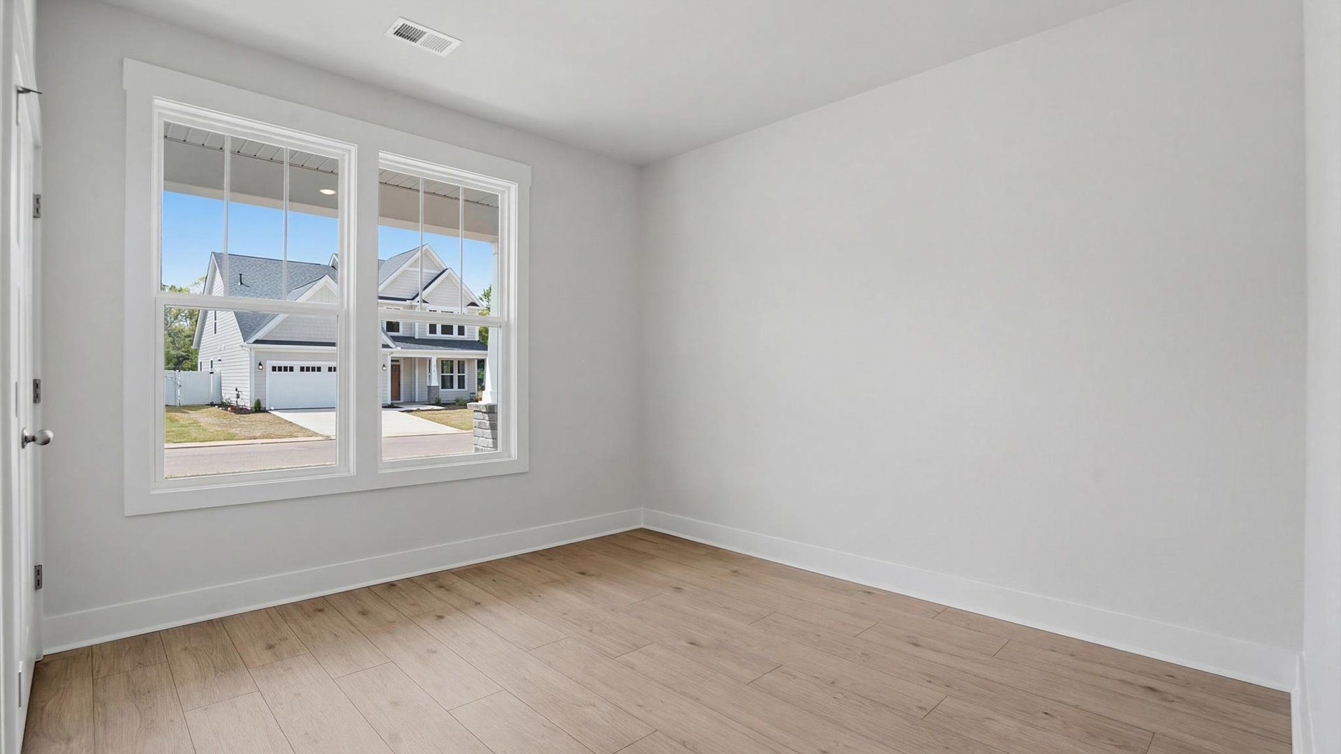 Functional secondary bedroom with hardwood flooring and modern touches in an exceptional layout at Pelham Crossing