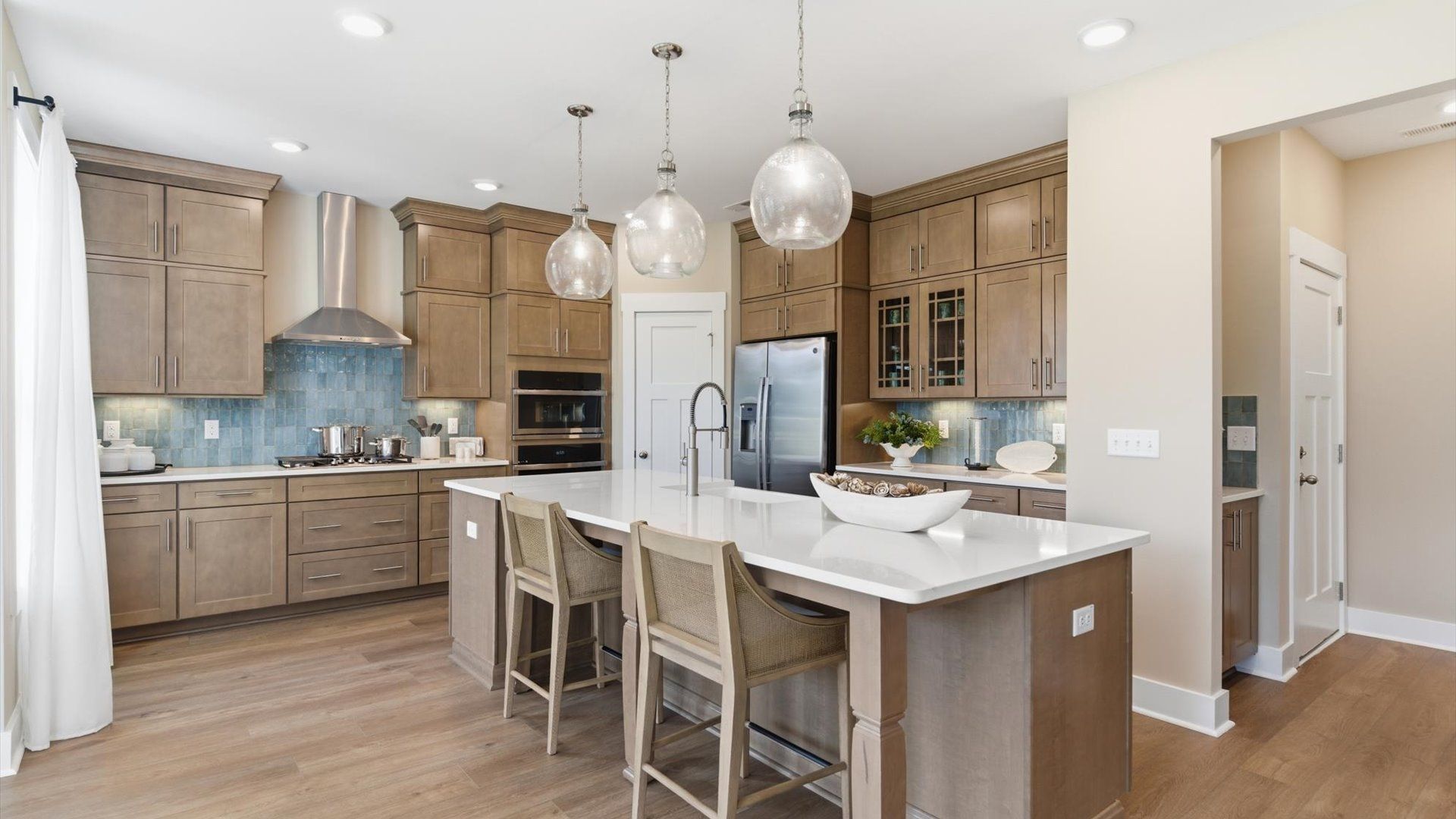 Tasteful kitchen with oversized island and stylish pendant lighting—crafted to high standards located in Woodruff, SC