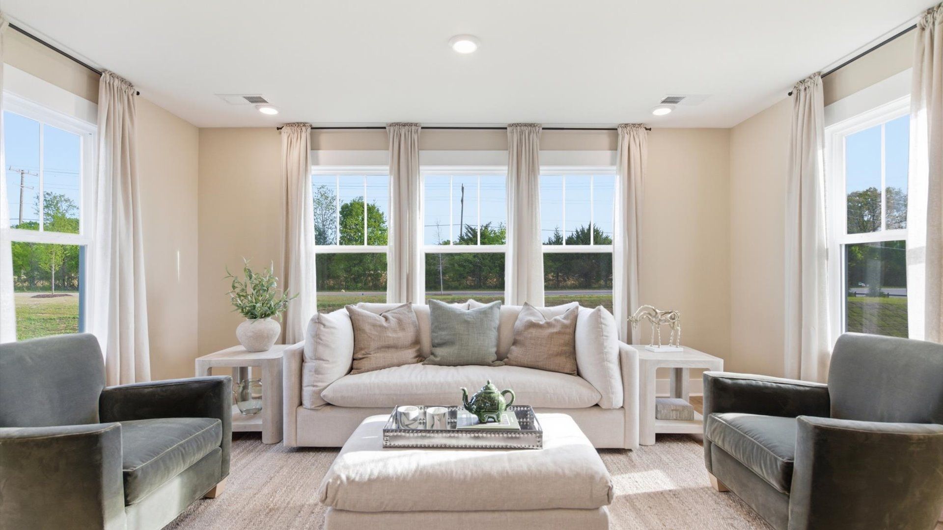 Serene and stylish primary bedroom featuring hardwood flooring and a thoughtful, modern layout at Benjamin's Grove