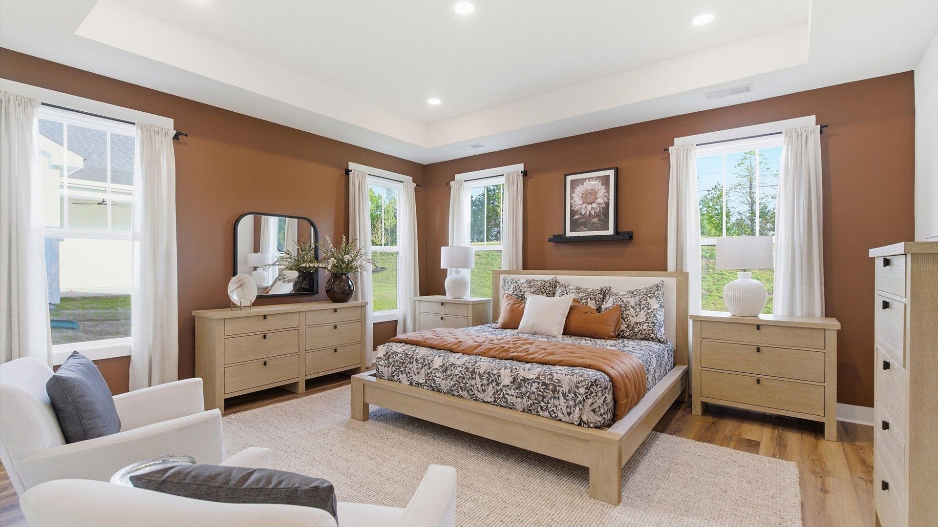 Eye-catching details and elegant finishes in the vibrant primary suite of this select home