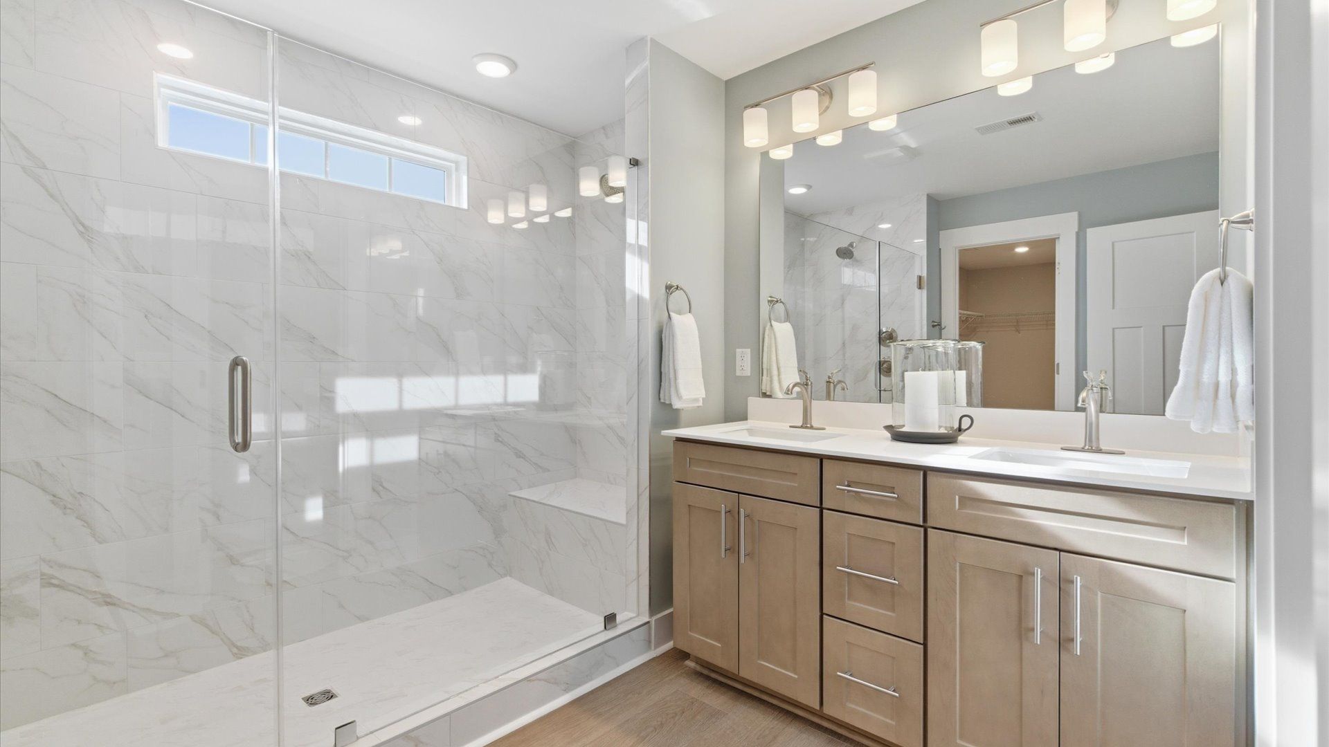 First-rate primary bathroom offering an elegant walk-in shower and dual sinks with superior style located at Benjamin's Grove