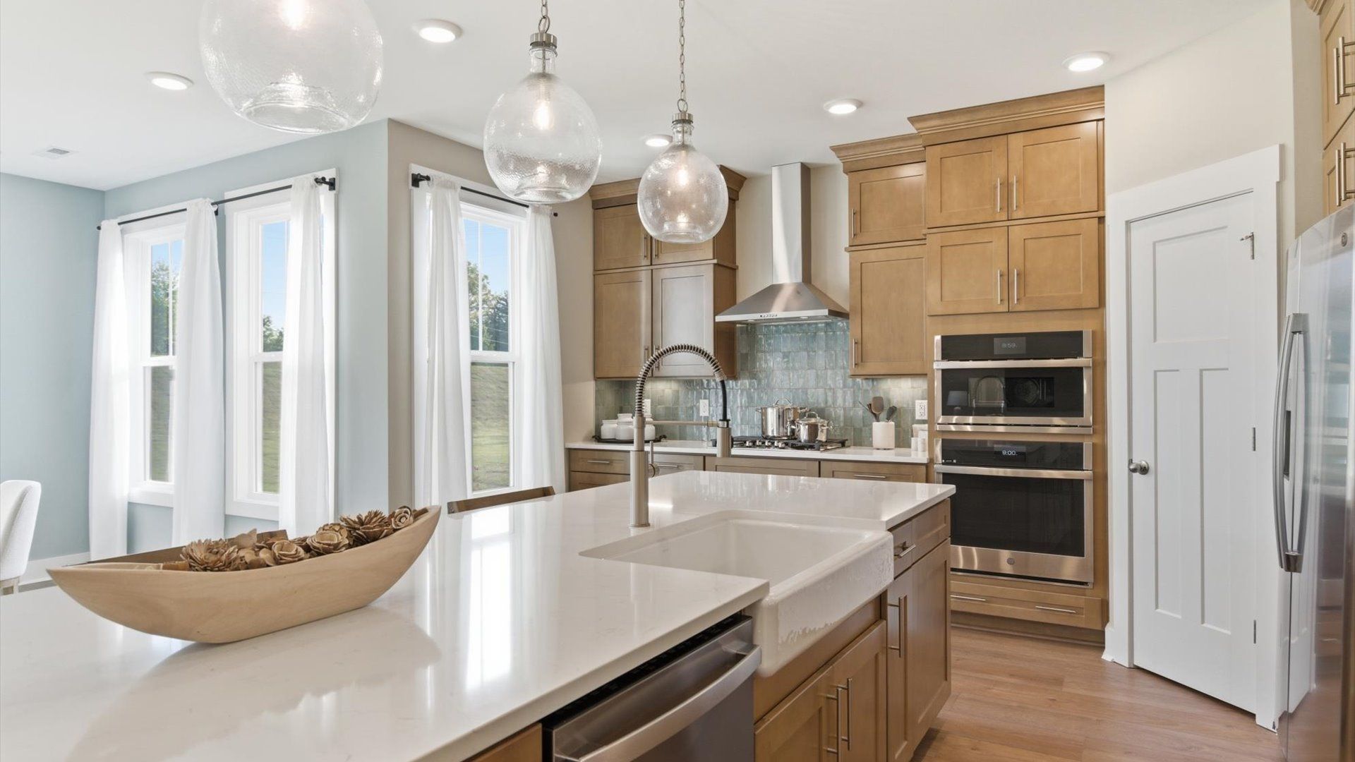 Tasteful kitchen with a streamlined island and modern finishes in a first-class DRB Homes design at Benjamin's Grove