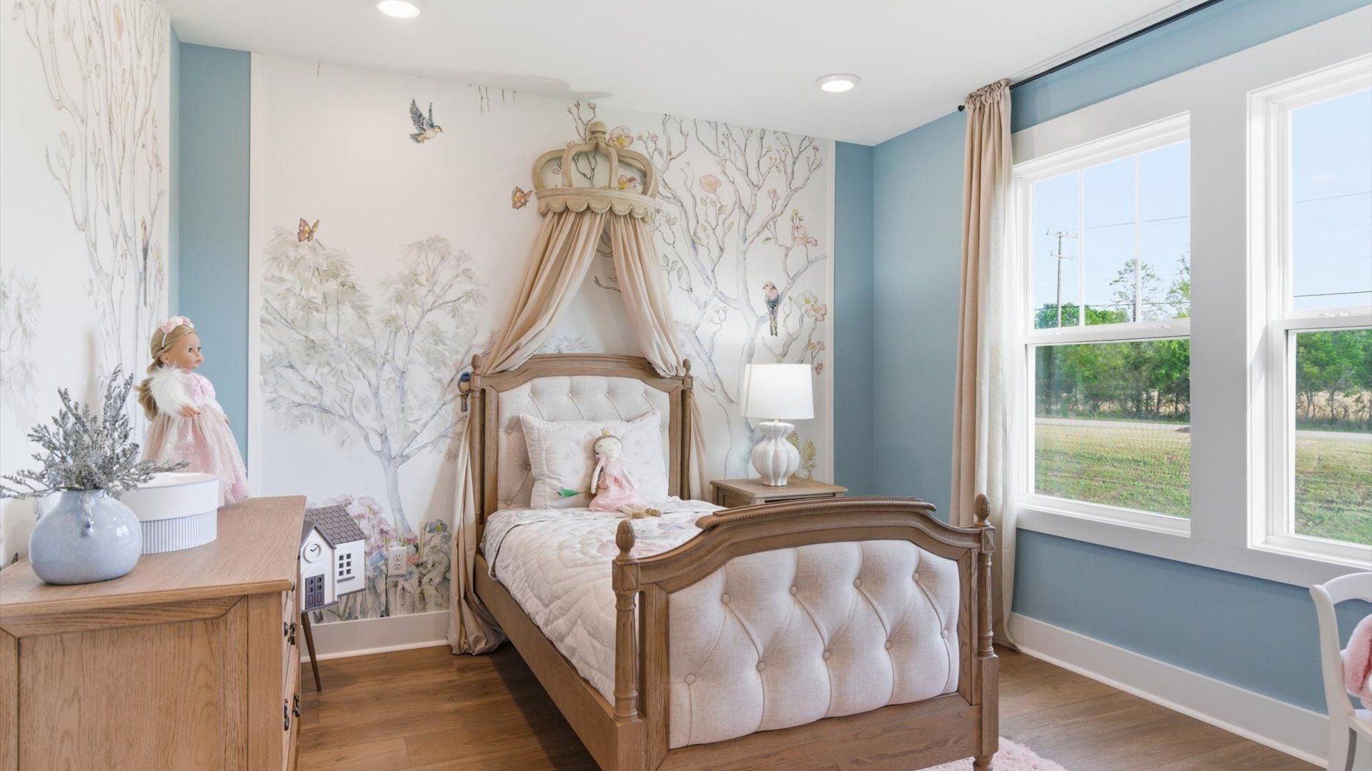 Accomplished design in this restful bedroom featuring hardwood floors and oversized window views