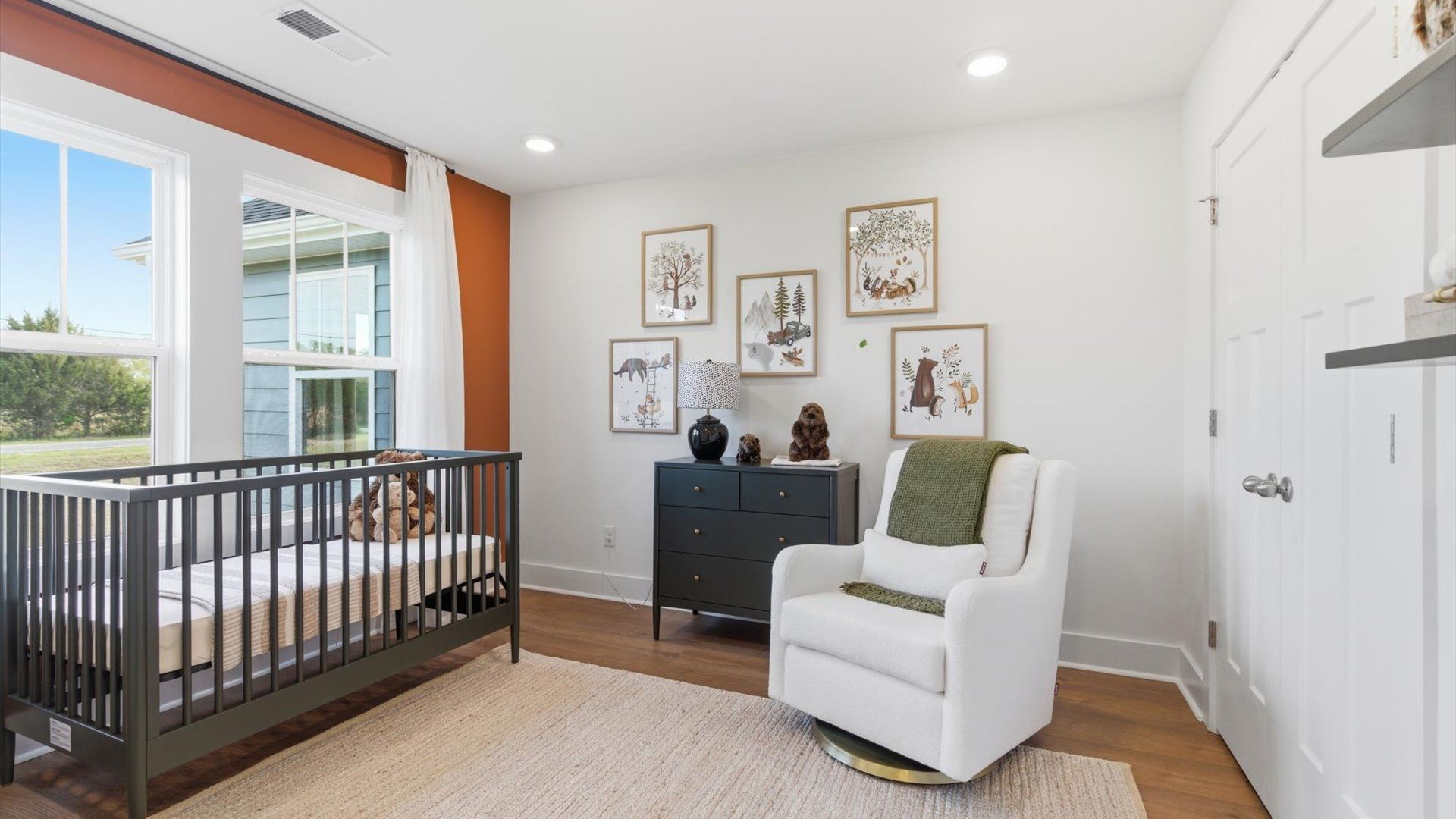 Bright and serene bedroom with hardwood flooring and large windows for vibrant light at Benjamin's Grove