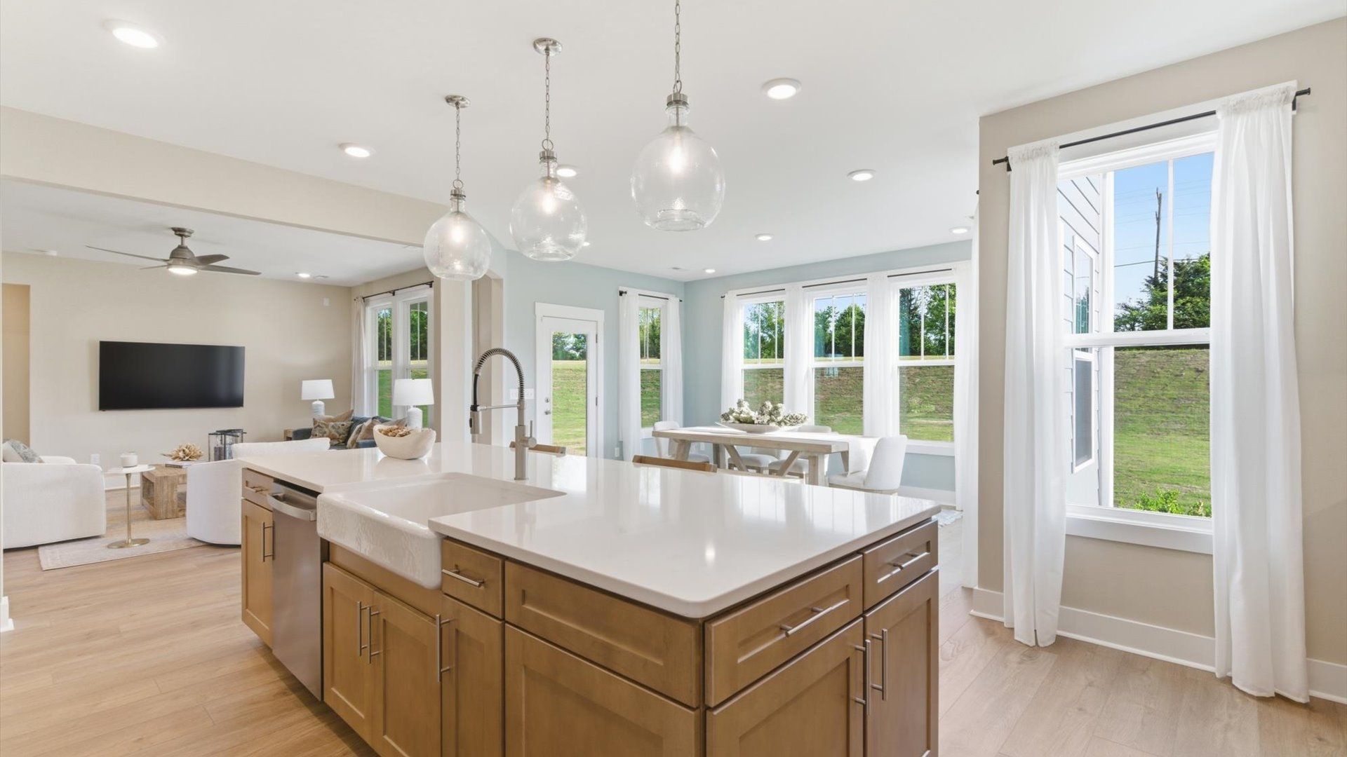 Highly skilled craftsmanship shines in this modern kitchen with pendant lighting and a central island focal point
