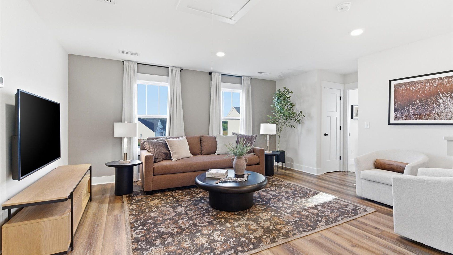 Functional loft with tasteful hardwood floors and exceptional natural light in a modern single family home